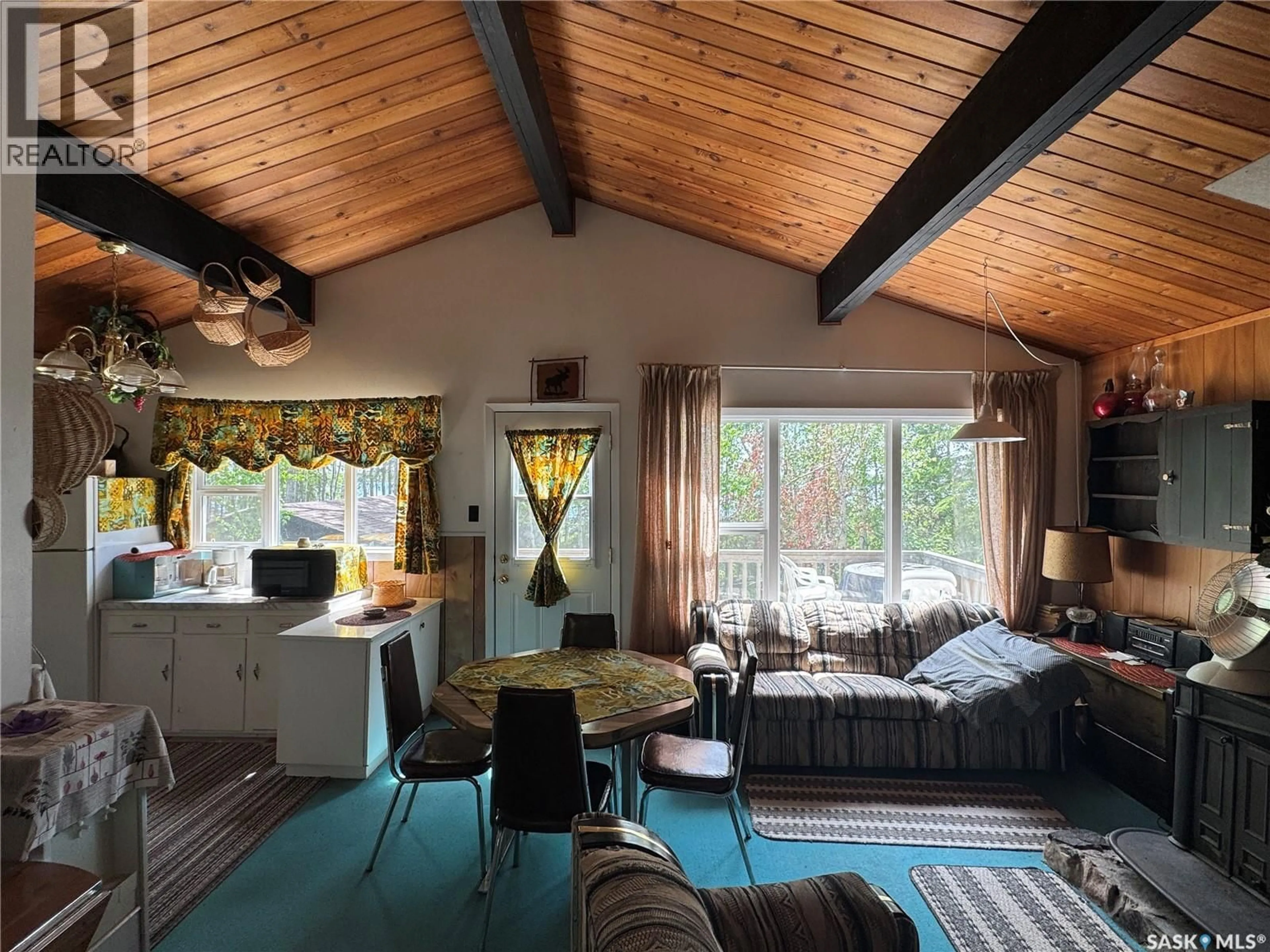 Living room with furniture, wood/laminate floor for 803 WILLOW STREET, Lac La Ronge Provincial Park Saskatchewan S0J1L0