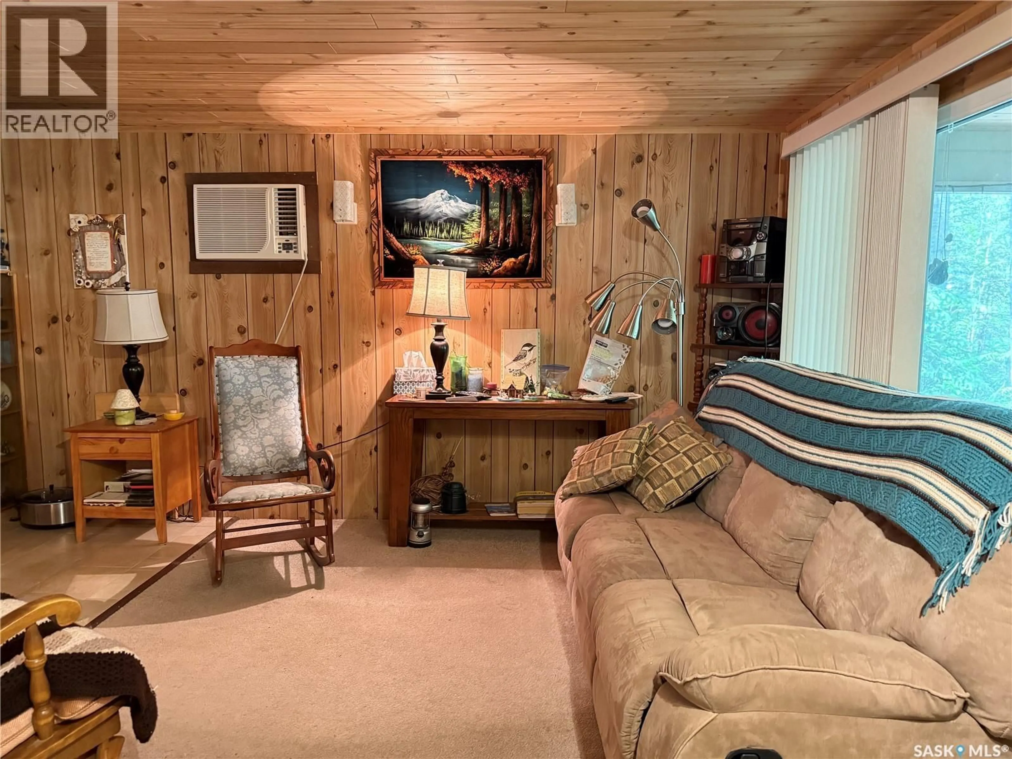 Living room with furniture, wood/laminate floor for 404 NORTHSHORE DRIVE, Northern Admin District Saskatchewan S0M0G0