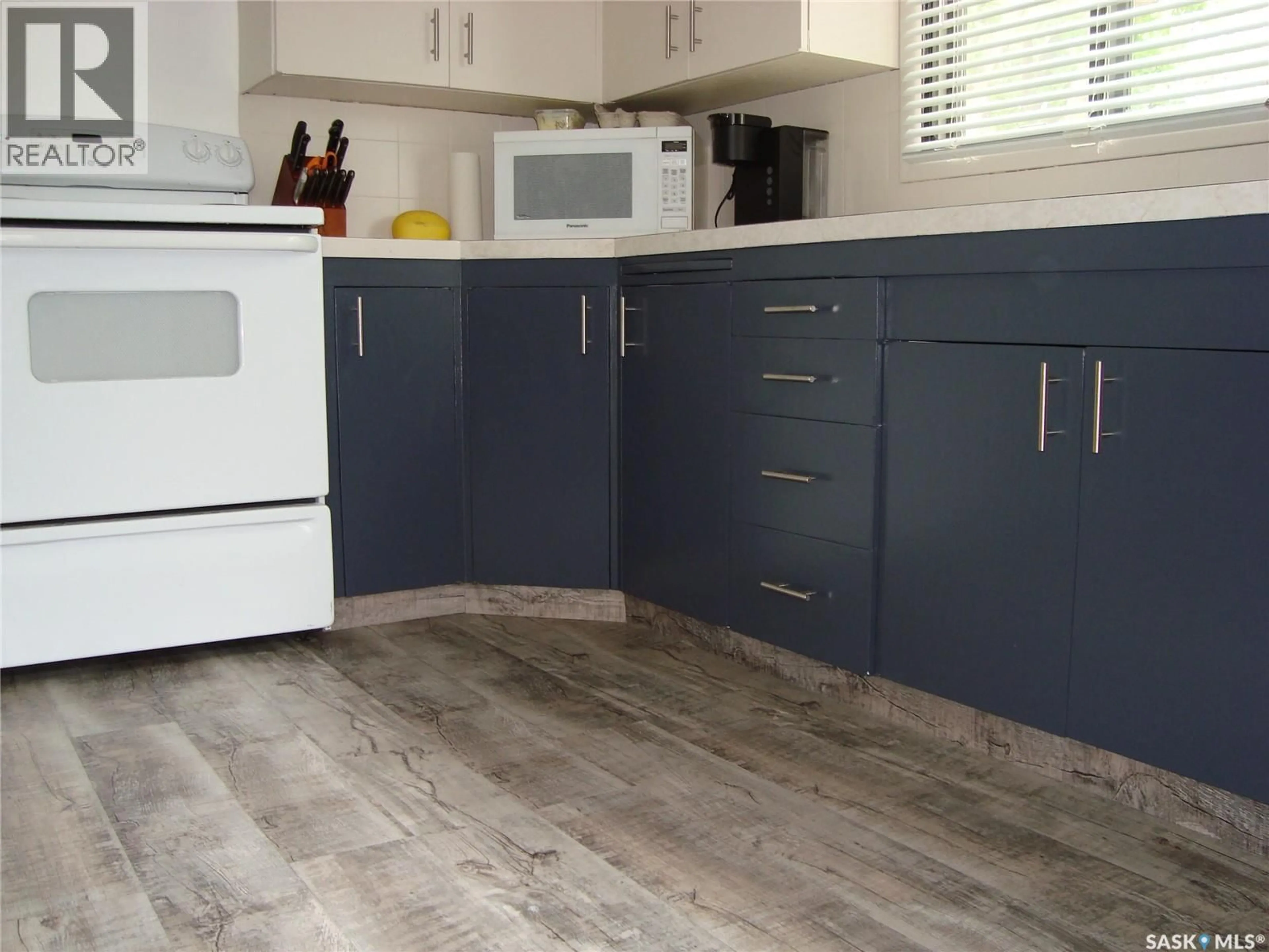 Open concept kitchen, wood/laminate floor for 1430 TAYLOR DRIVE, Swift Current Saskatchewan S9H1M9