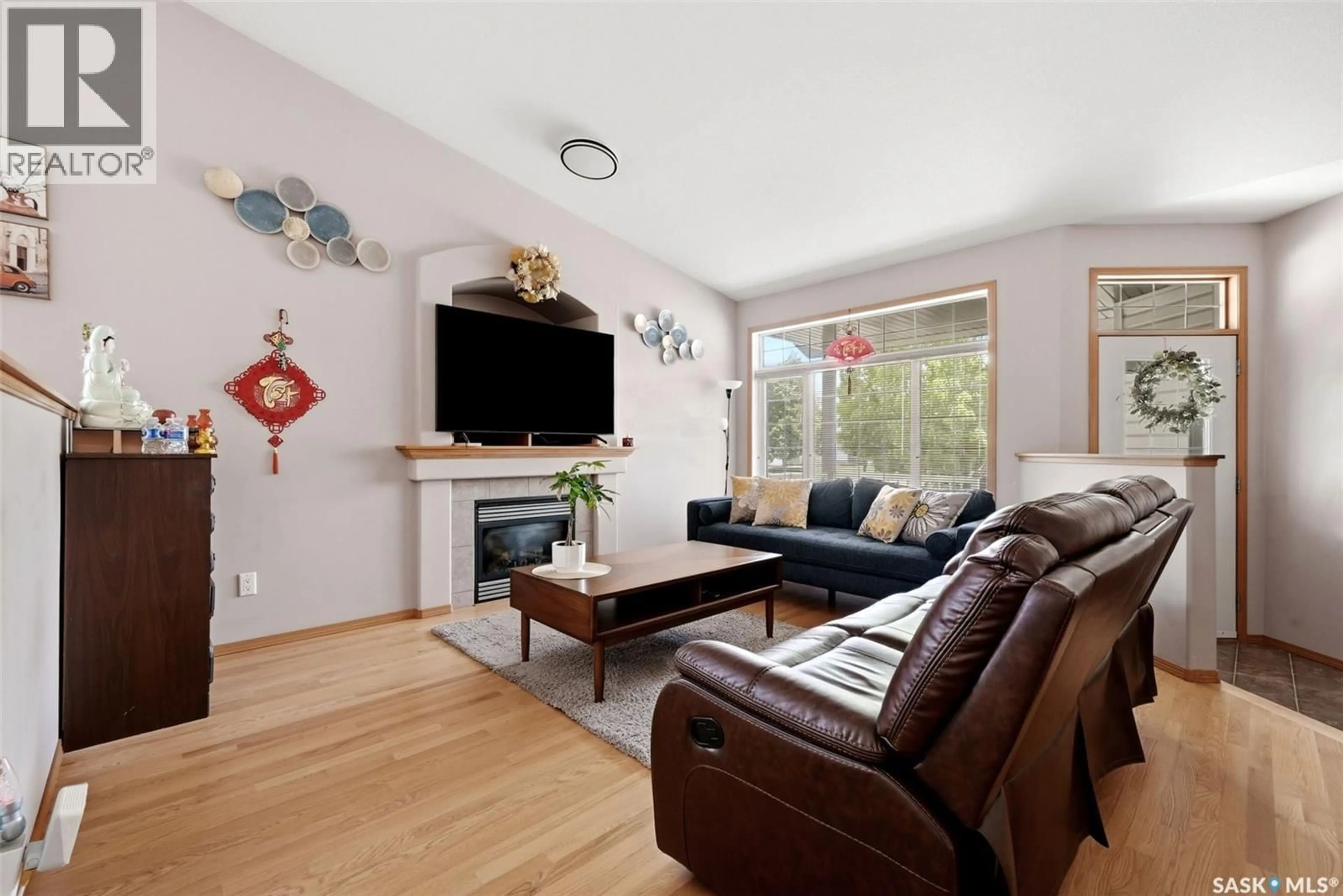 Living room with furniture, wood/laminate floor for 5022 BOSWELL CRESCENT, Regina Saskatchewan S4X4P9