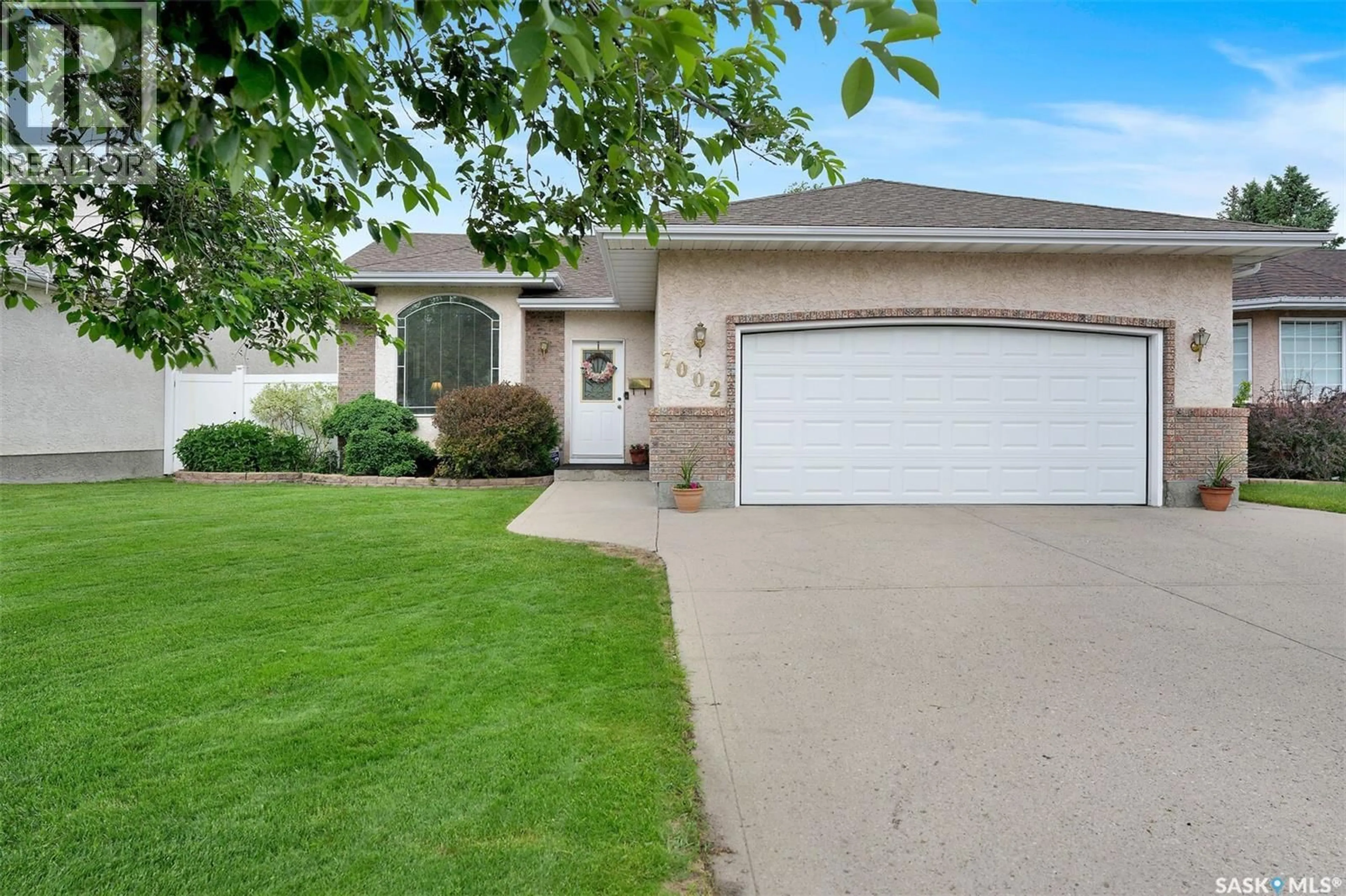 Home with vinyl exterior material, street for 7002 MAPLE WOOD CRESCENT, Regina Saskatchewan S4X4J9