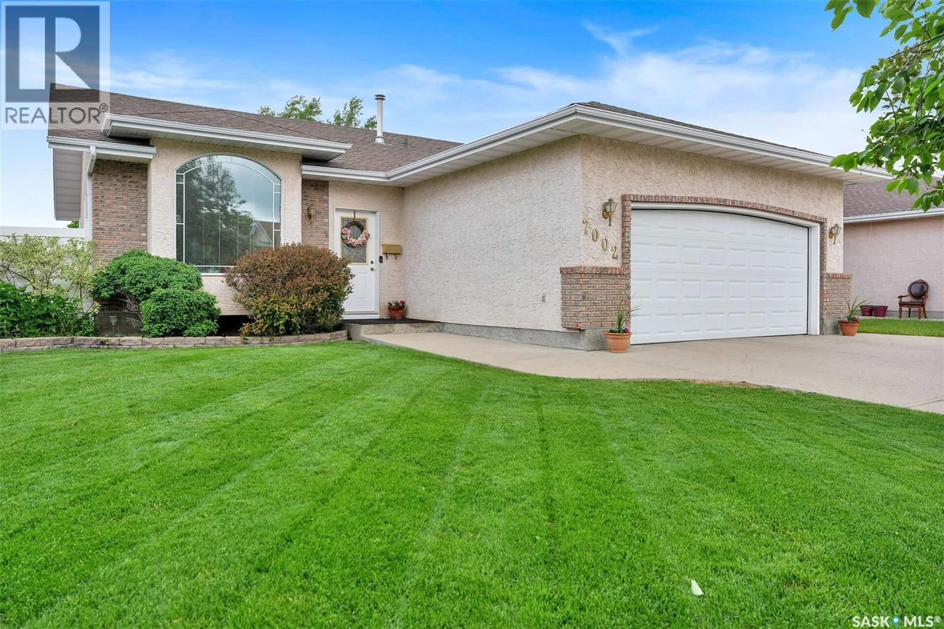 Home with vinyl exterior material, street for 7002 MAPLE WOOD CRESCENT, Regina Saskatchewan S4X4J9