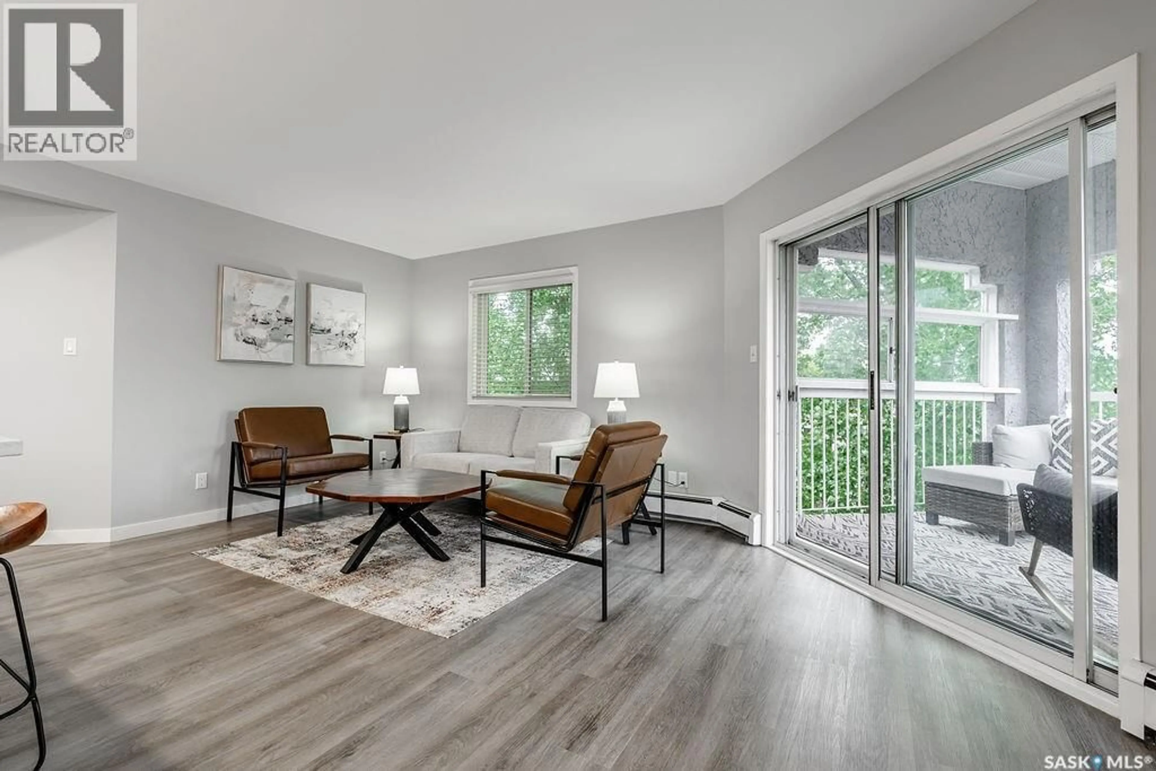 Living room with furniture, wood/laminate floor for 304 - 1215 LOUISE AVENUE, Saskatoon Saskatchewan S7H2P8