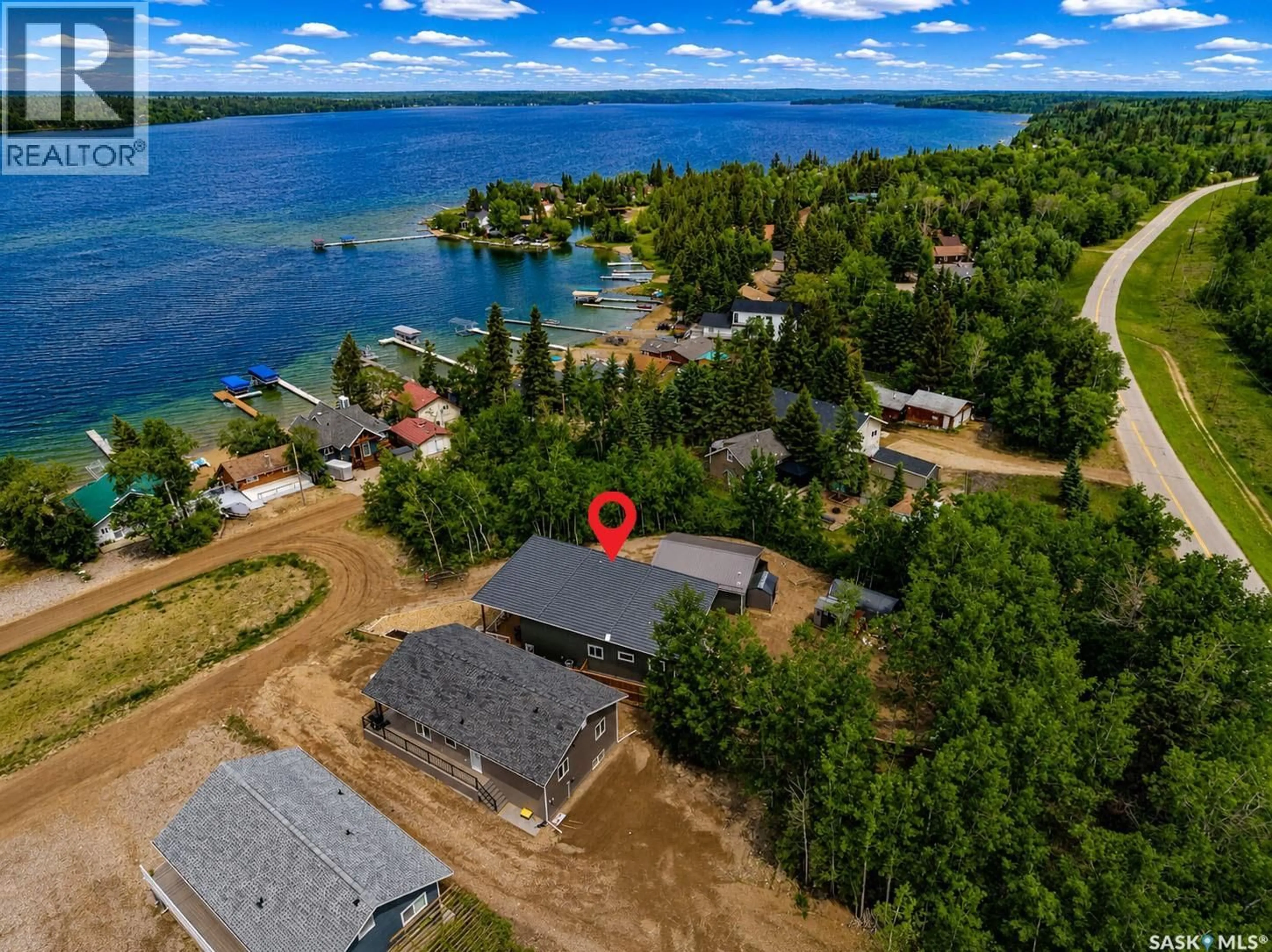 A pic from outside/outdoor area/front of a property/back of a property/a pic from drone, water/lake/river/ocean view for 115 JACOBSON COVE, Lakeland Rm No. 521 Saskatchewan S0J0N0