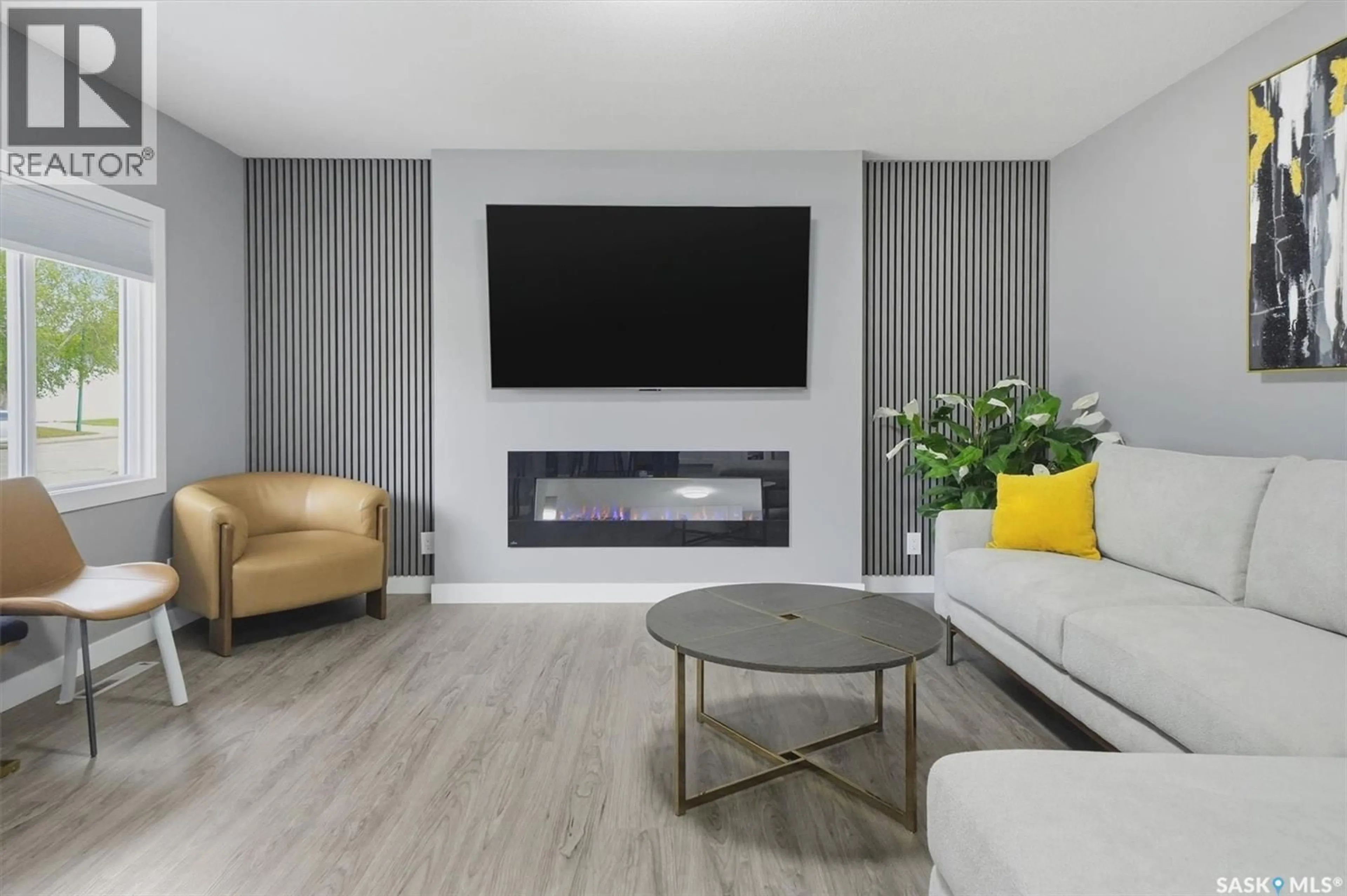 Living room with furniture, wood/laminate floor for 1924 DUFFERIN AVENUE, Saskatoon Saskatchewan S7J1B7