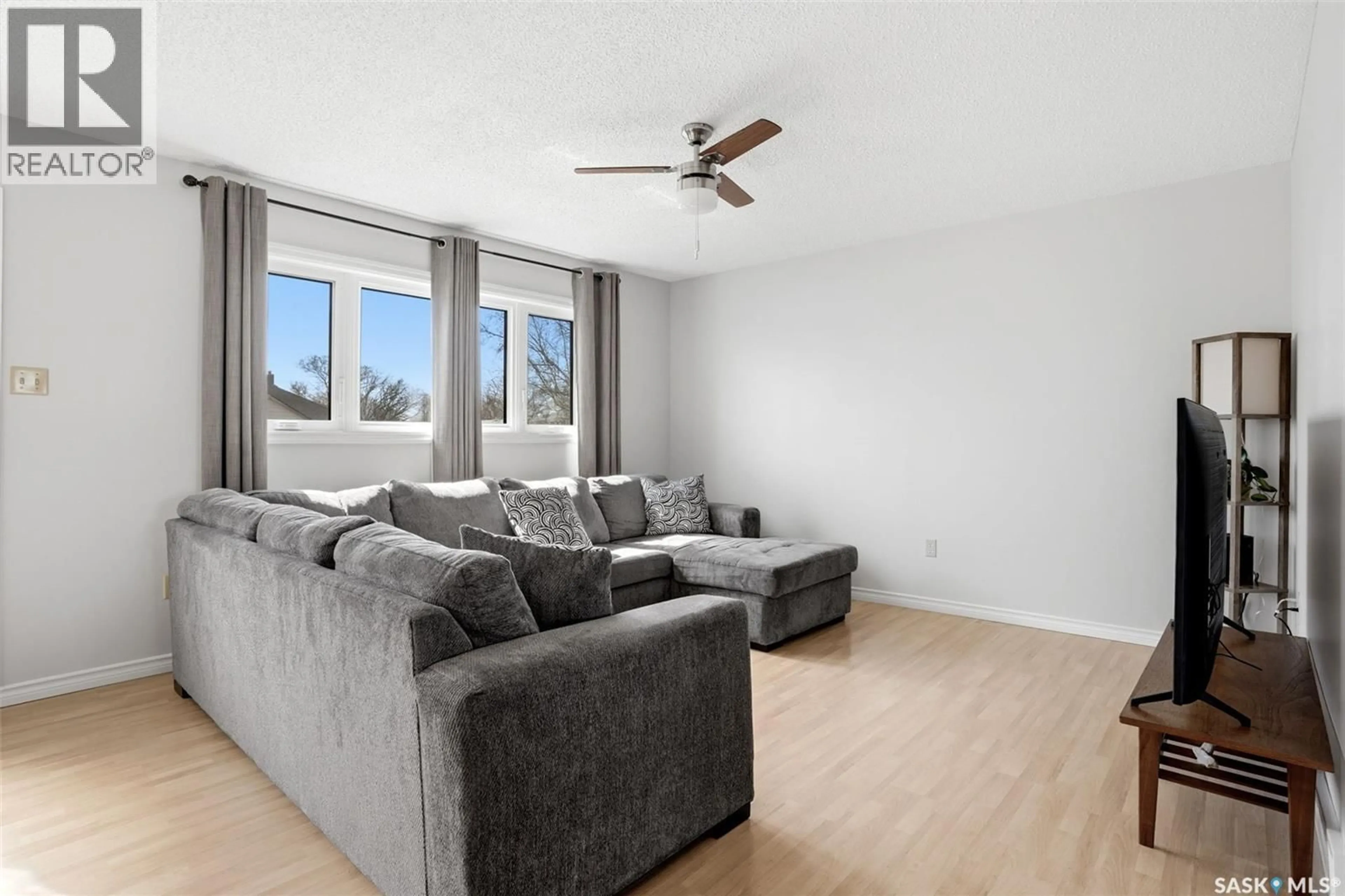 Living room with furniture, wood/laminate floor for 327 COTEAU STREET, Milestone Saskatchewan S0G3L0