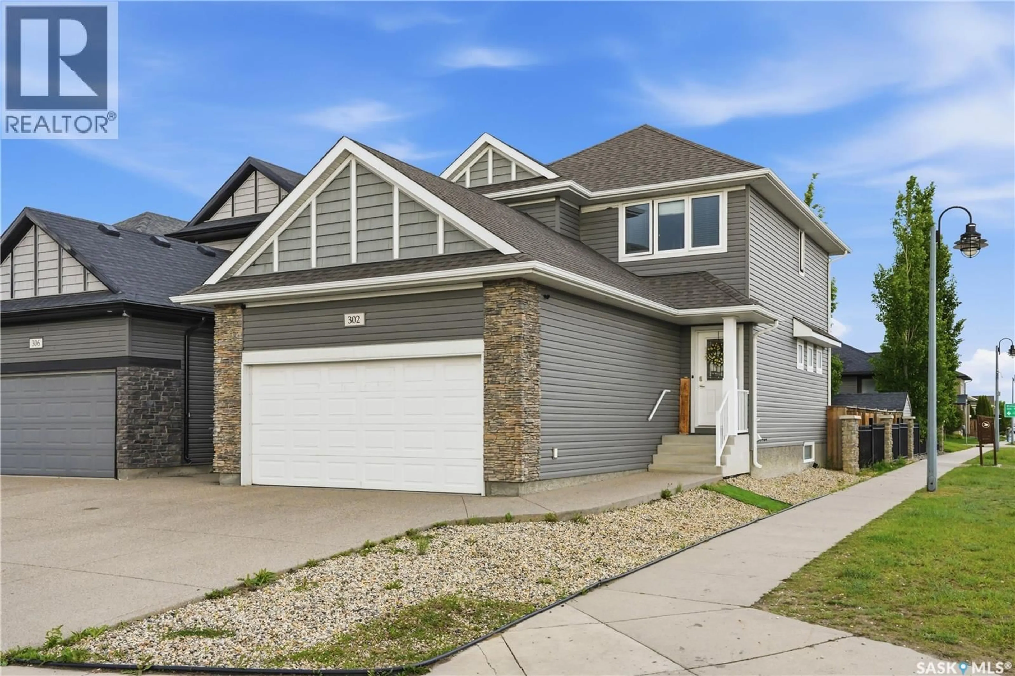 Home with vinyl exterior material, street for 302 DICKSON CRESCENT, Saskatoon Saskatchewan S7T0T8