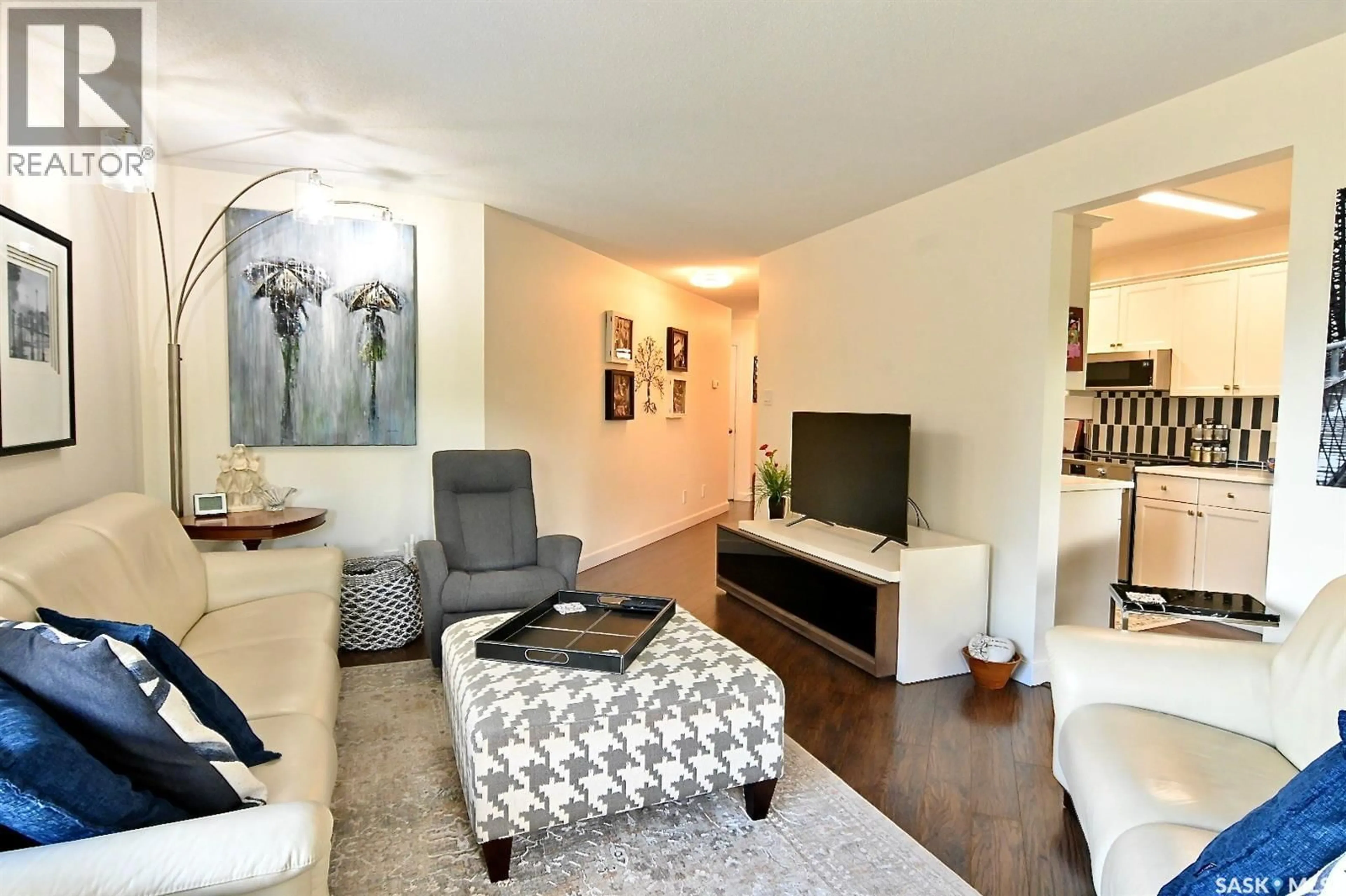 Living room with furniture, wood/laminate floor for 213 2305 ADELAIDE STREET E, Saskatoon Saskatchewan S7J5H6