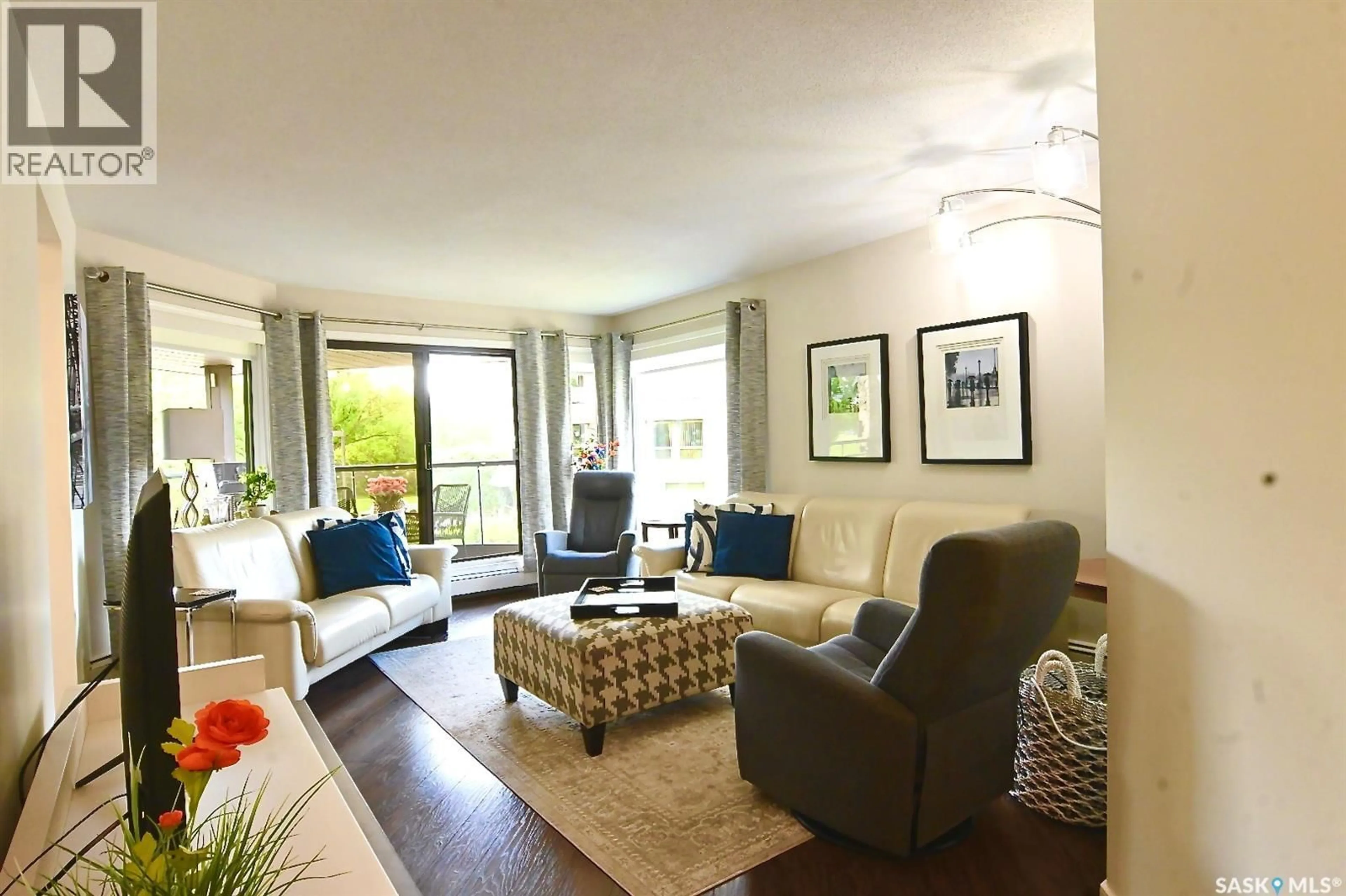 Living room with furniture, wood/laminate floor for 213 2305 ADELAIDE STREET E, Saskatoon Saskatchewan S7J5H6