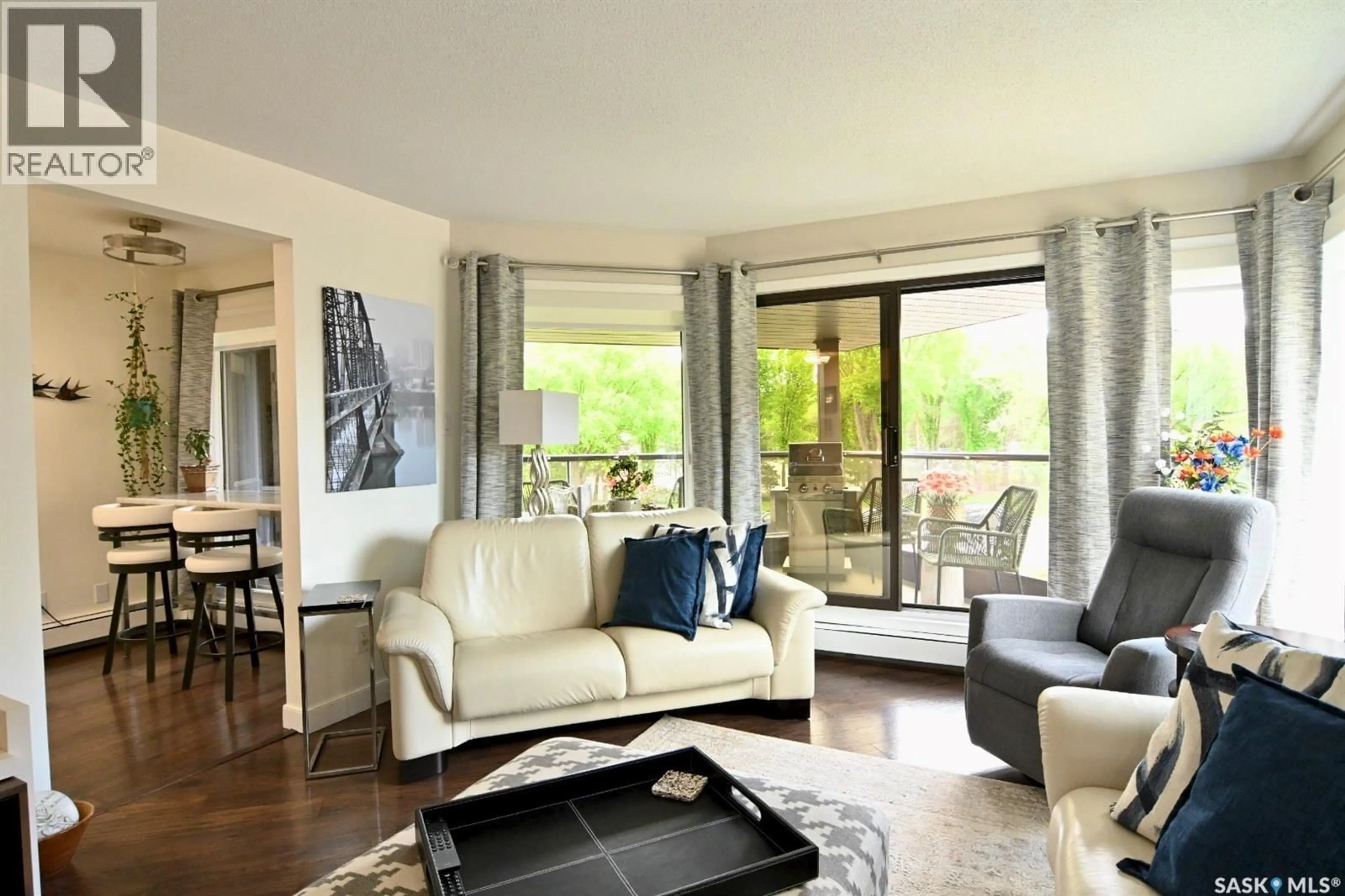 Living room with furniture, wood/laminate floor for 213 2305 ADELAIDE STREET E, Saskatoon Saskatchewan S7J5H6