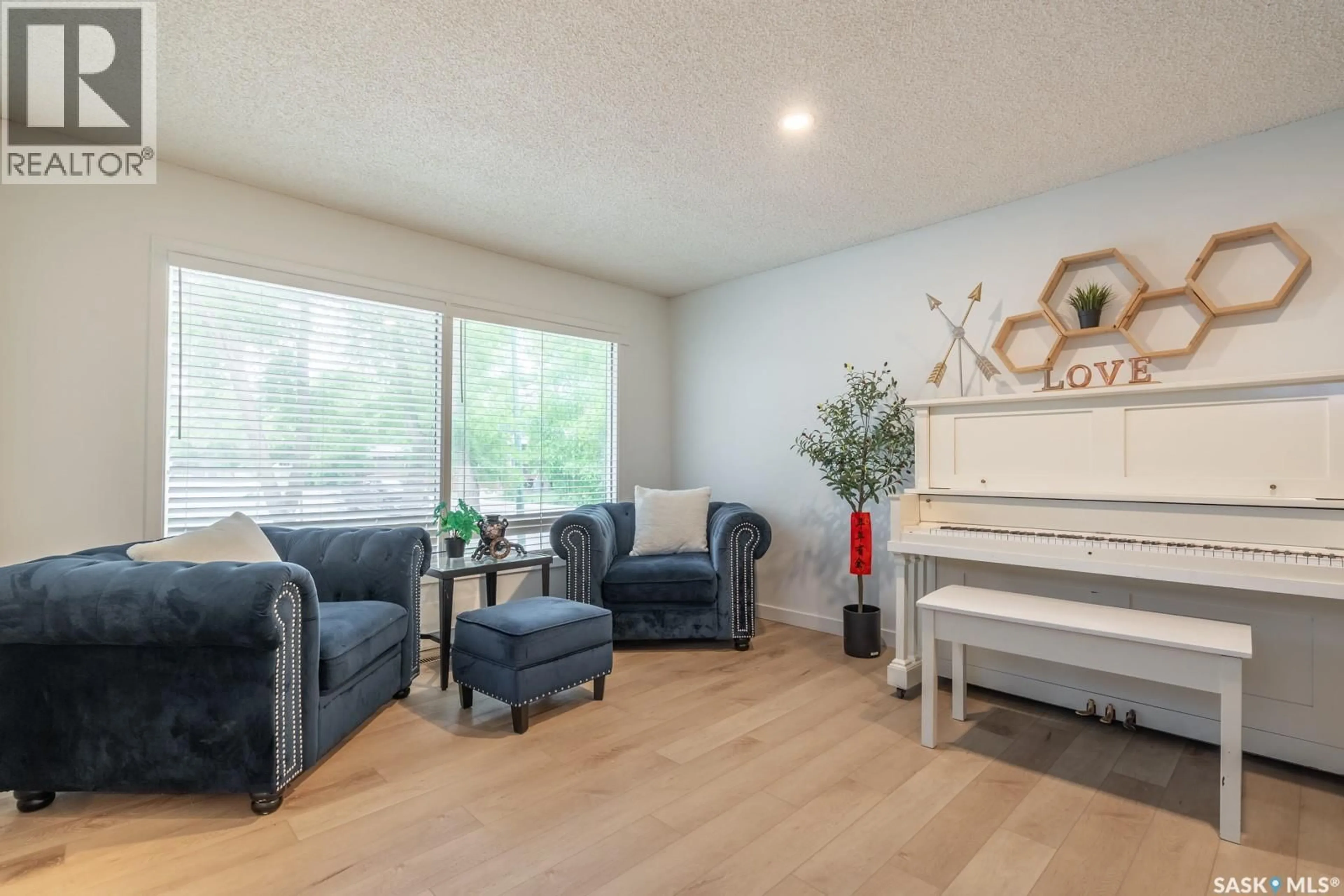 Living room with furniture, wood/laminate floor for 3312 PORTNALL AVENUE, Regina Saskatchewan S4S2B6