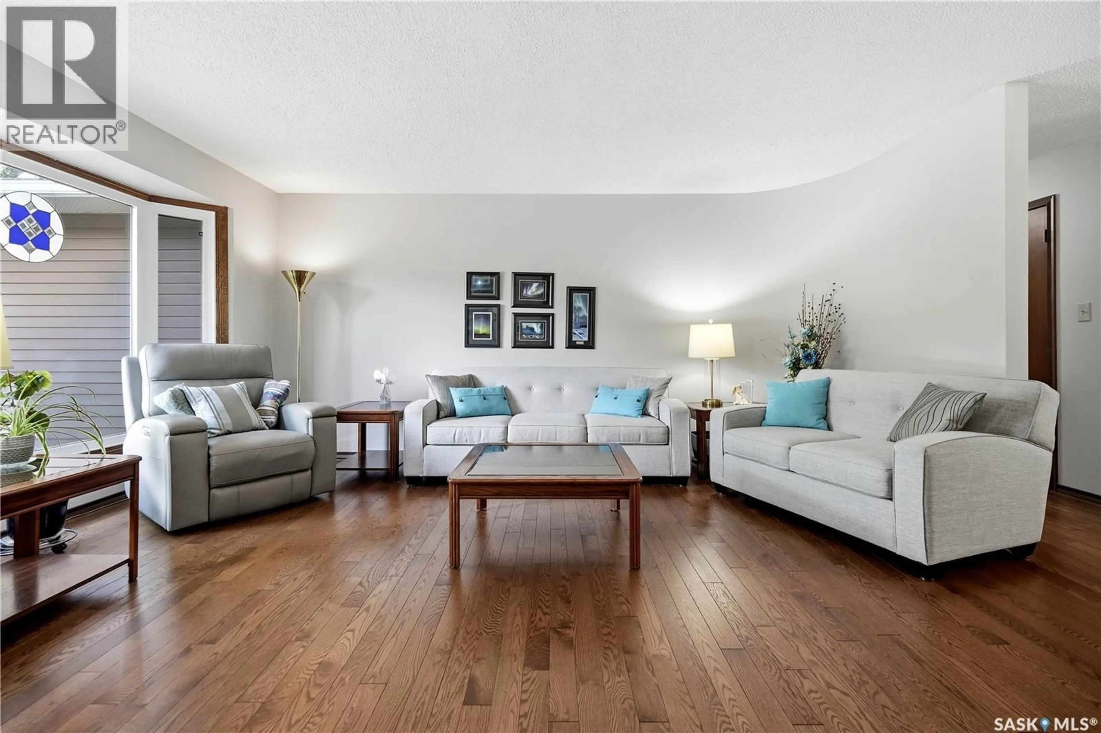 Living room with furniture, wood/laminate floor for 15 MINOT DRIVE, Regina Saskatchewan S4X1B5