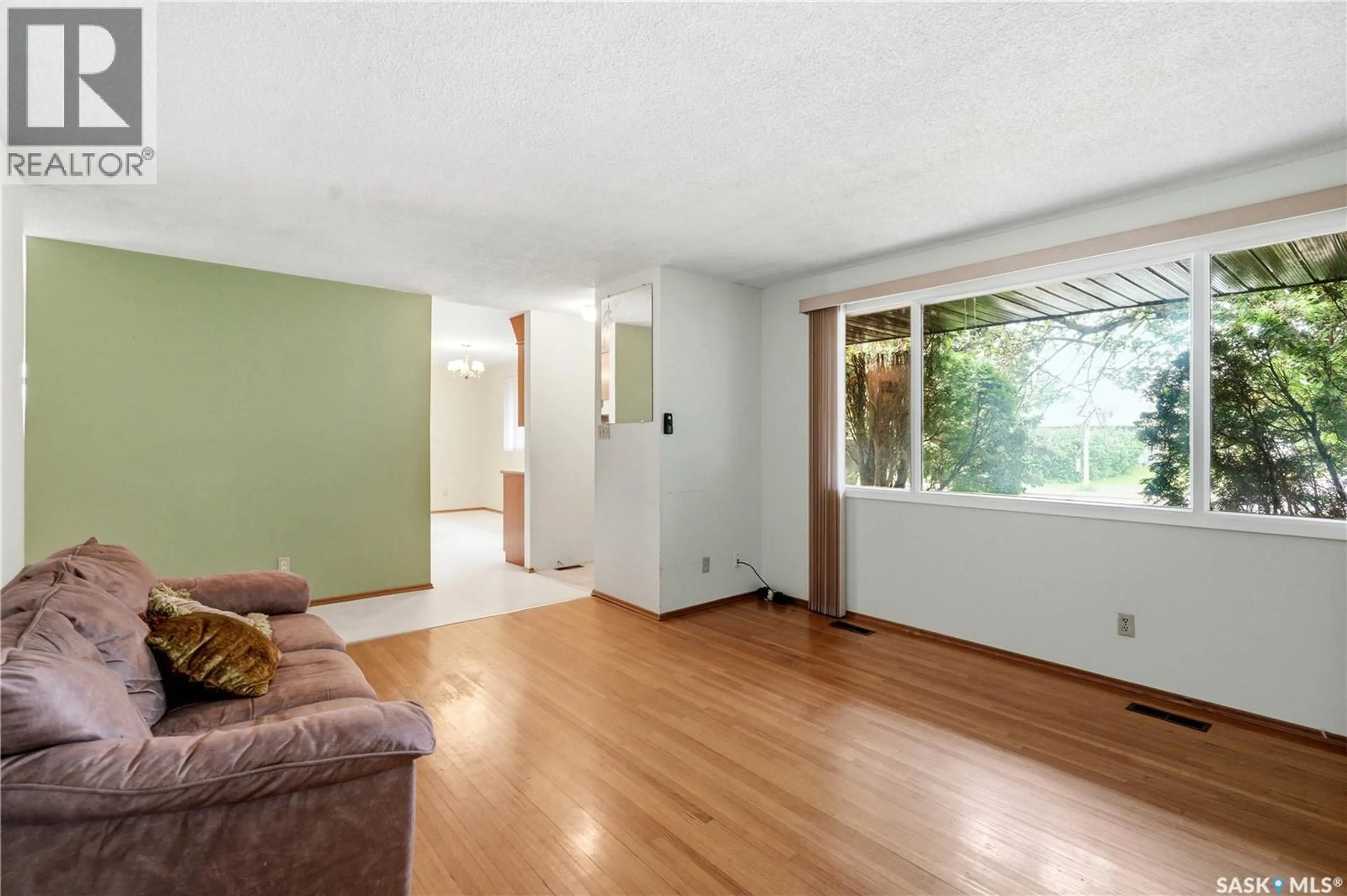 Living room with furniture, wood/laminate floor for 1922 RICHARDSON ROAD, Saskatoon Saskatchewan S7L0C4