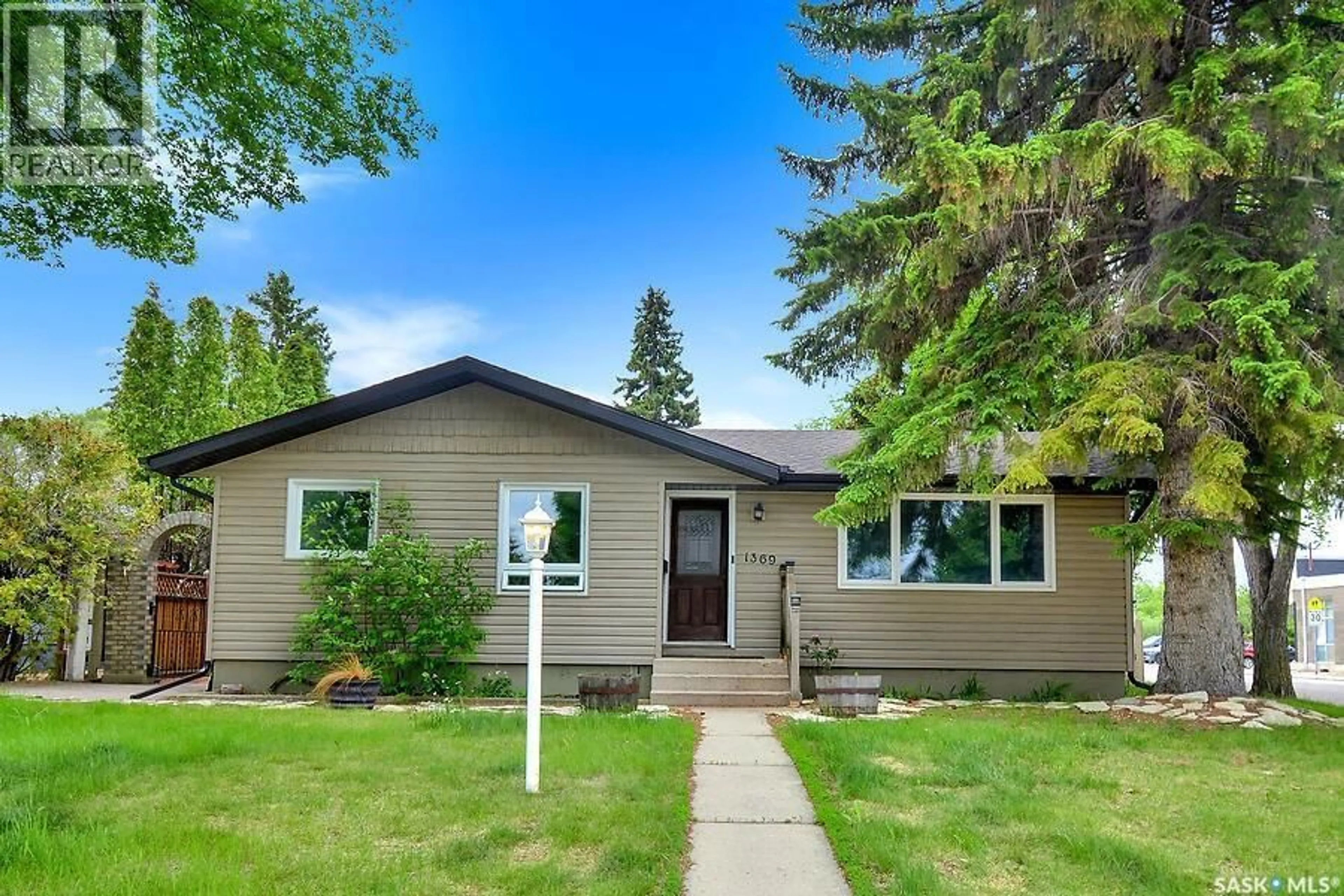Home with vinyl exterior material, street for 1369 EAST CENTRE, Saskatoon Saskatchewan S7J3A8