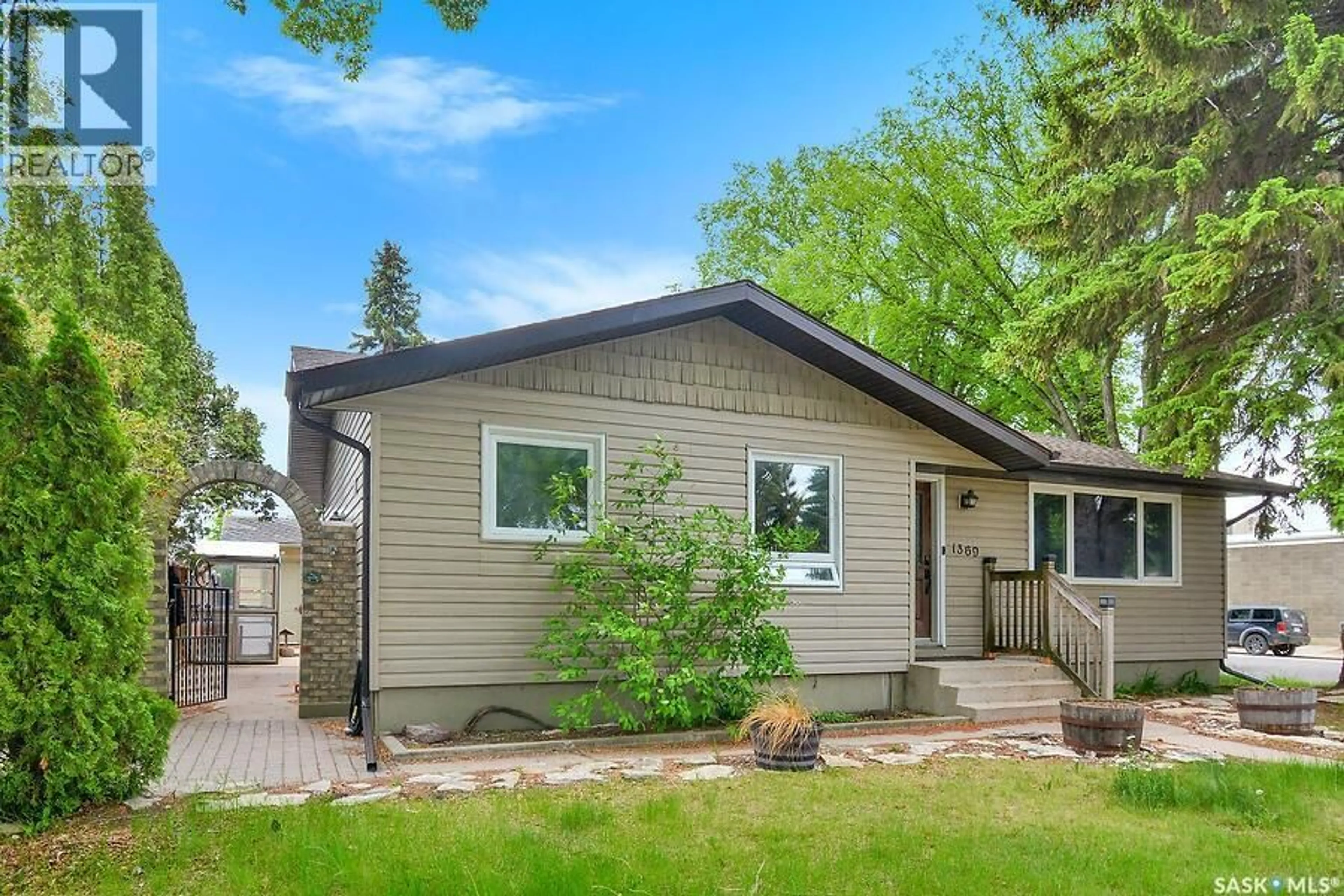 Home with vinyl exterior material, street for 1369 EAST CENTRE, Saskatoon Saskatchewan S7J3A8