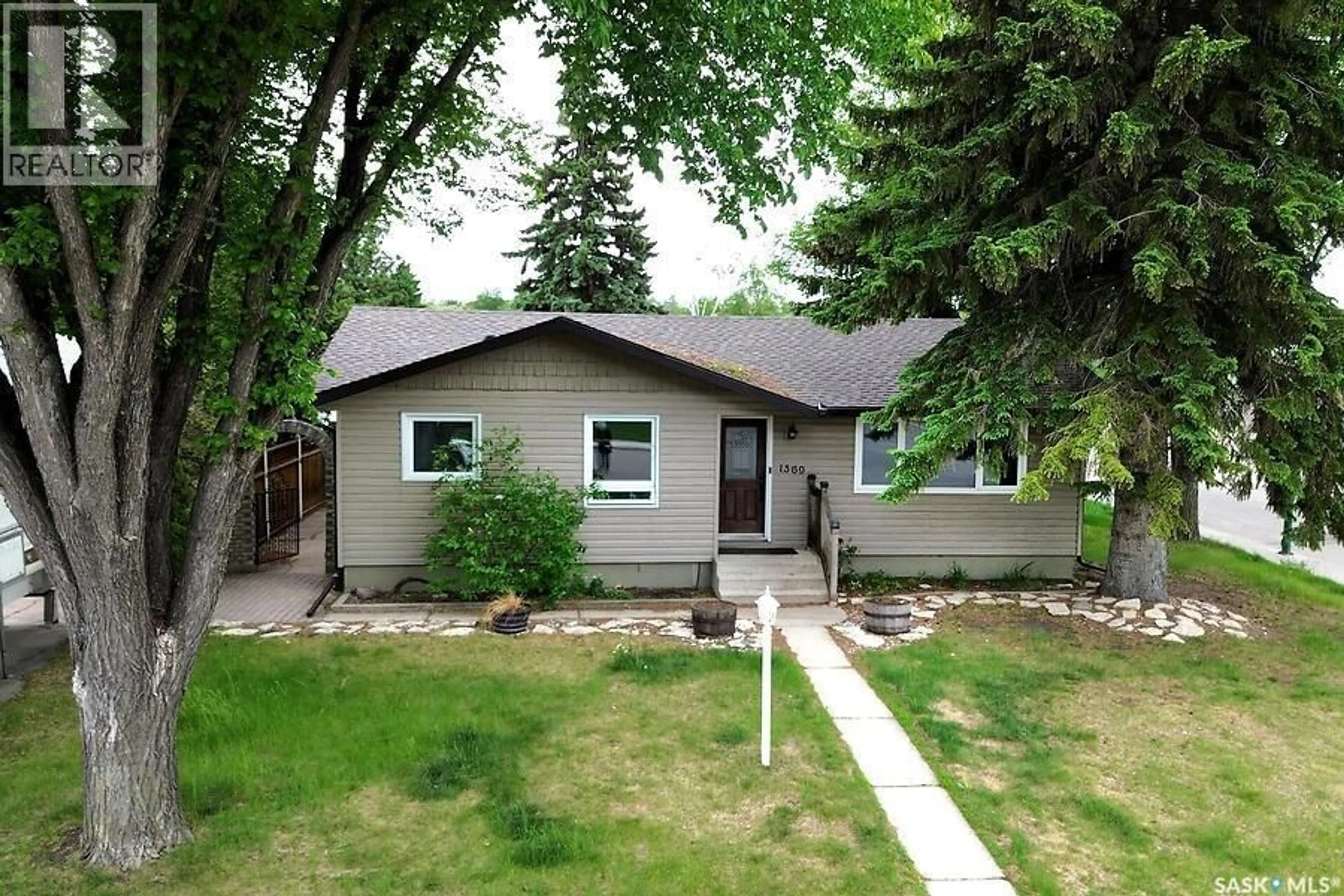 Home with vinyl exterior material, street for 1369 EAST CENTRE, Saskatoon Saskatchewan S7J3A8