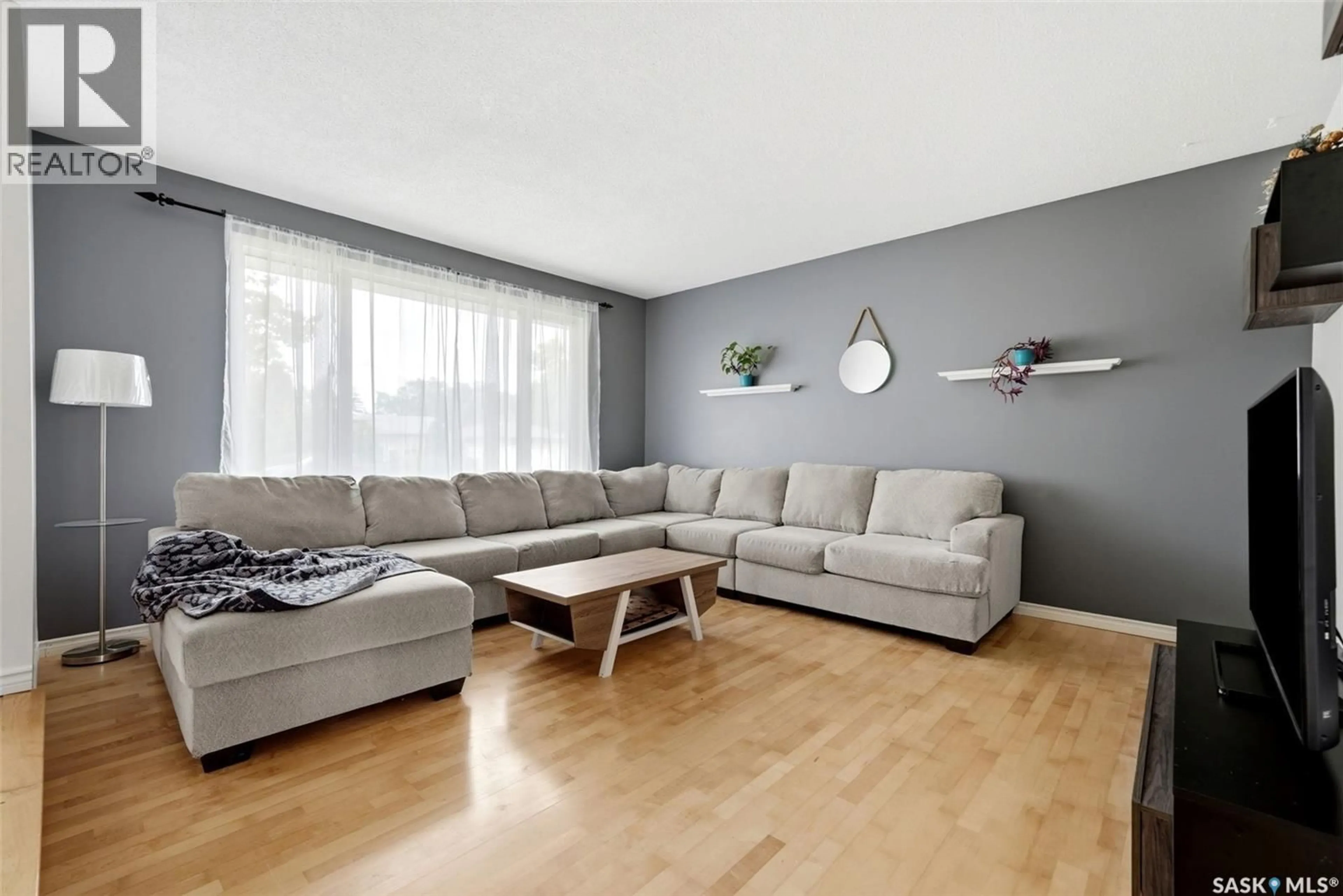 Living room with furniture, wood/laminate floor for 942 BROAD STREET, Regina Saskatchewan S4R5V7