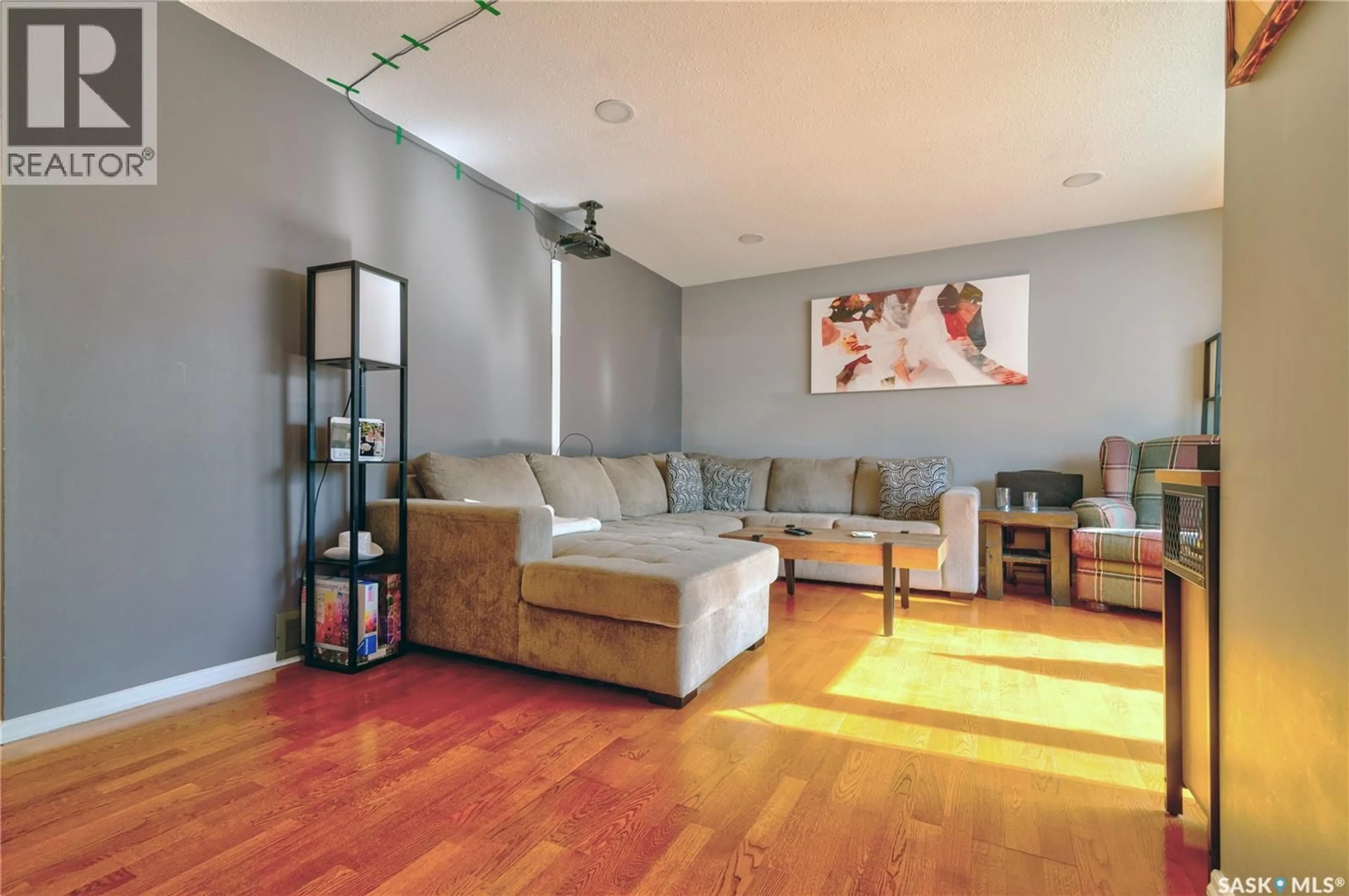 Living room with furniture, wood/laminate floor for 66 DENNY CRESCENT, Regina Saskatchewan S4N5J9