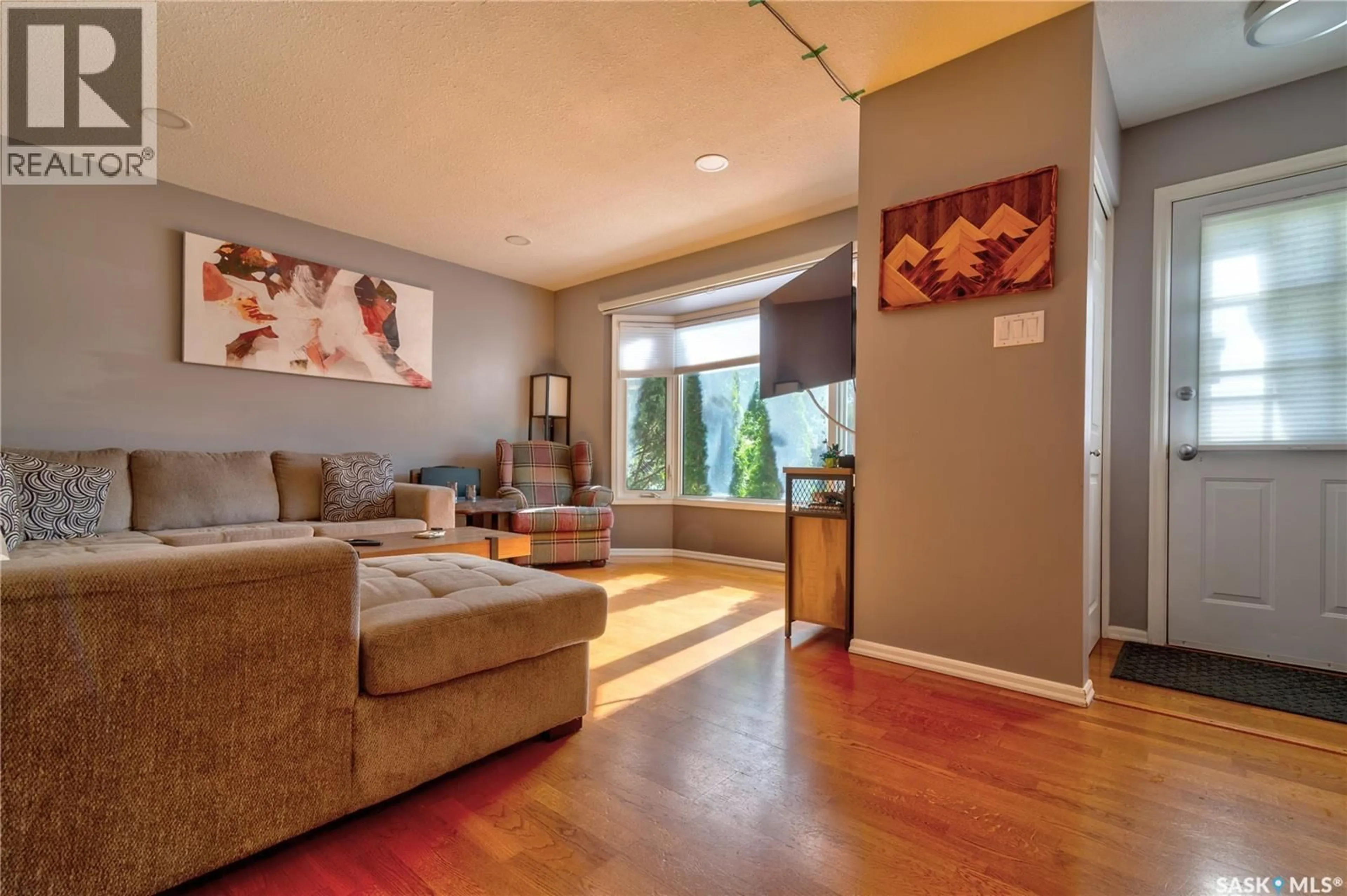 Living room with furniture, wood/laminate floor for 66 DENNY CRESCENT, Regina Saskatchewan S4N5J9