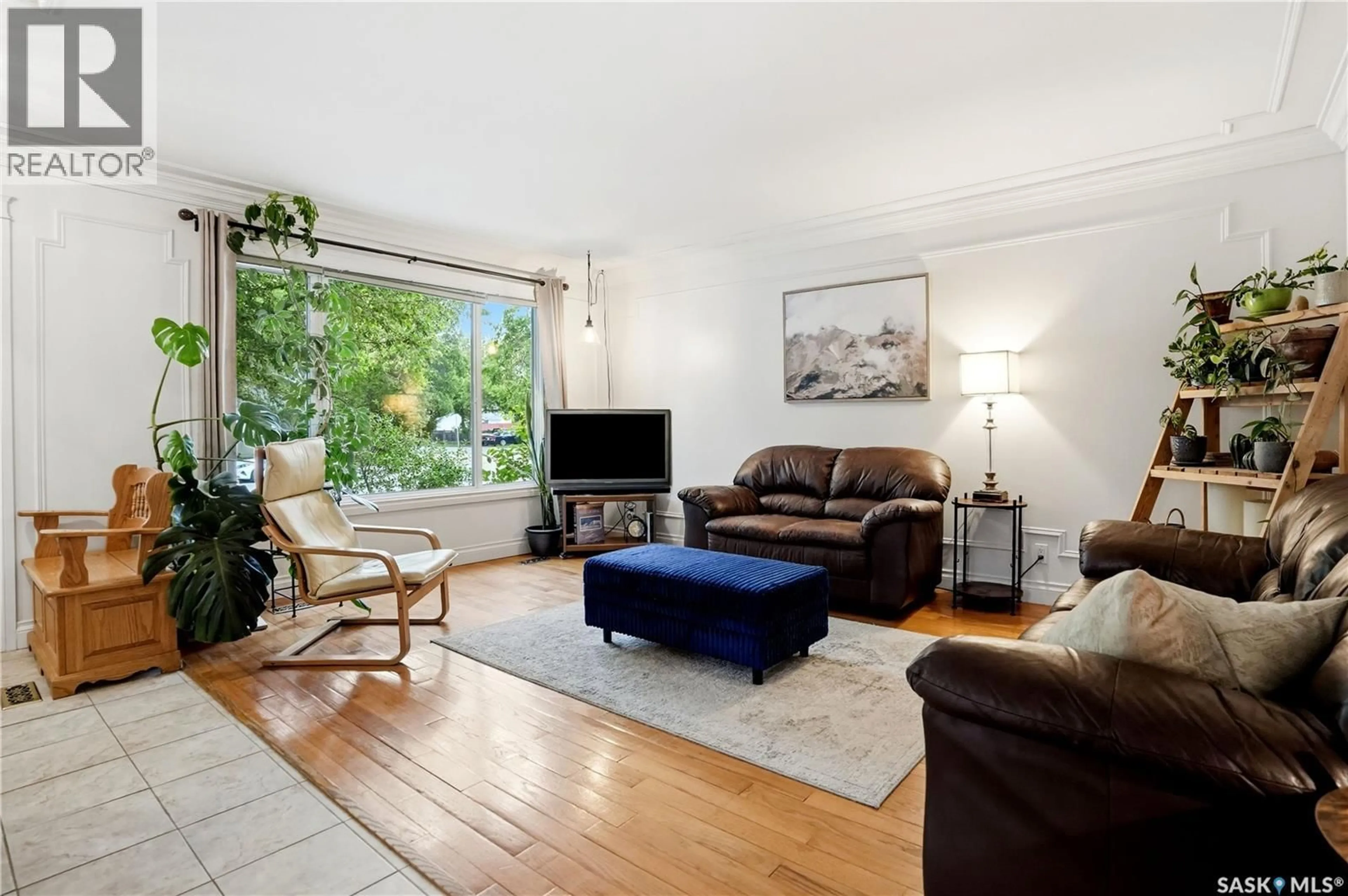 Living room with furniture, wood/laminate floor for 6207 1ST AVENUE, Regina Saskatchewan S4T7A1