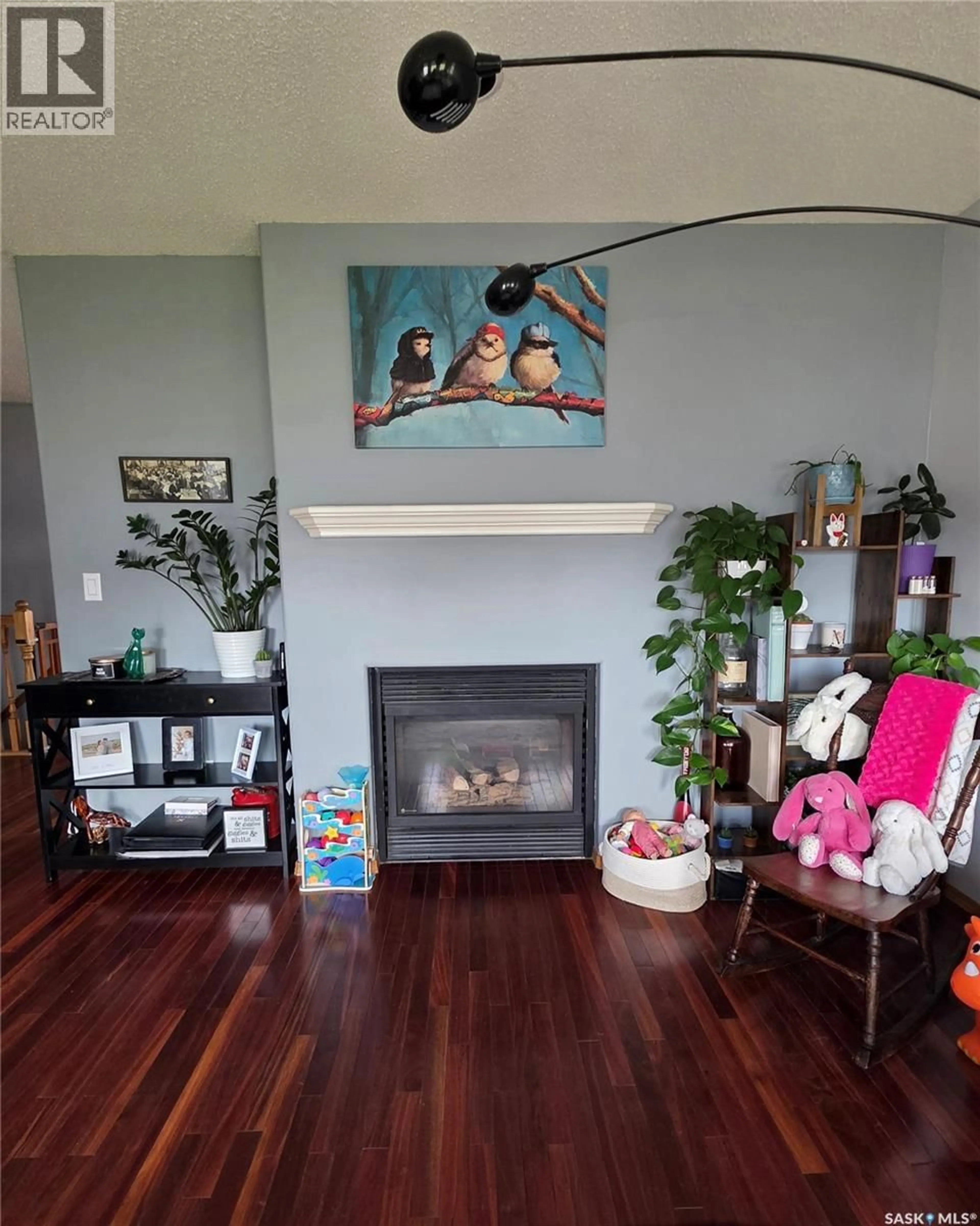 Living room with furniture, wood/laminate floor for 705 SUN VALLEY DRIVE, Estevan Saskatchewan S4A2R1