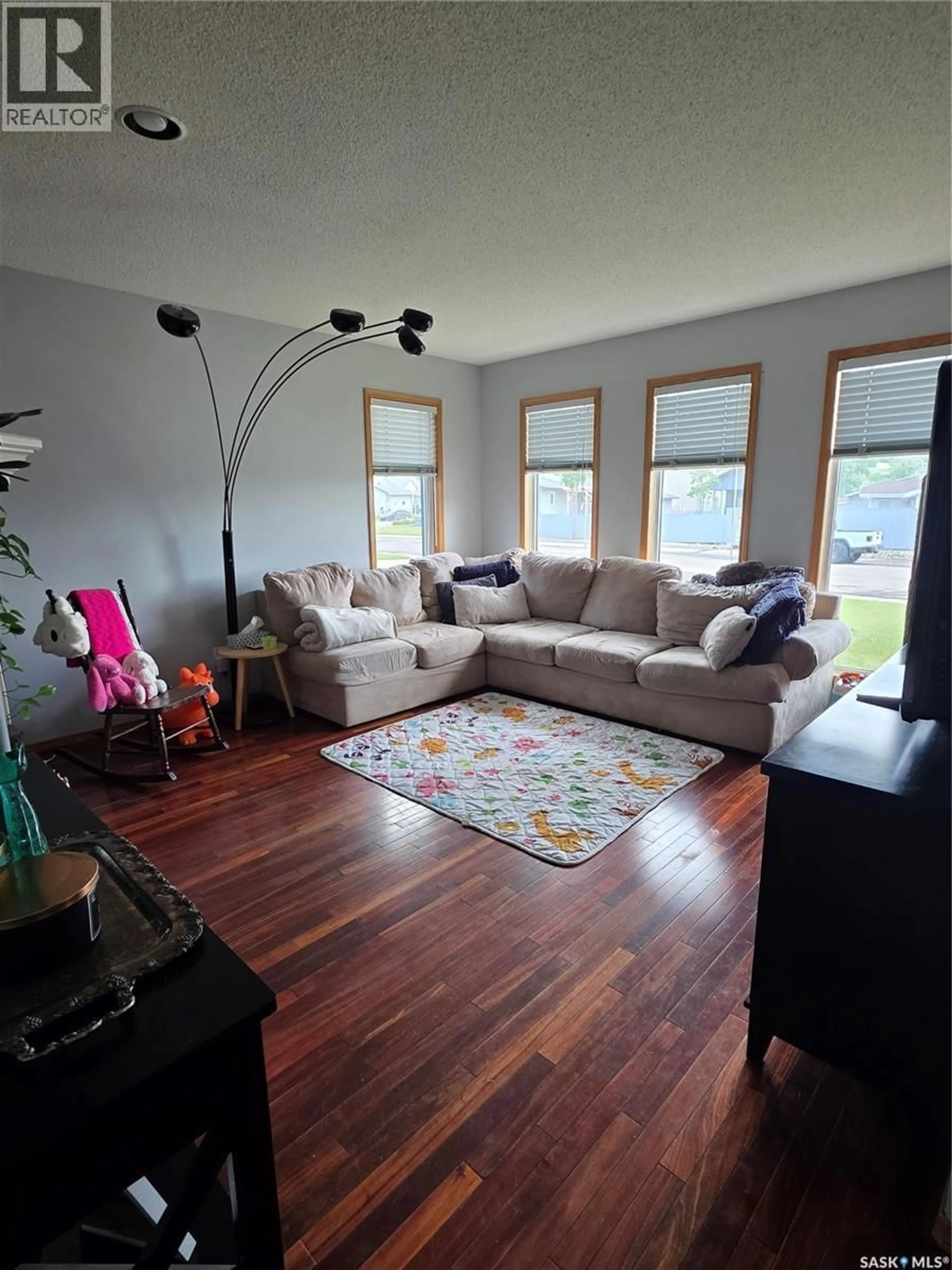 Living room with furniture, wood/laminate floor for 705 SUN VALLEY DRIVE, Estevan Saskatchewan S4A2R1