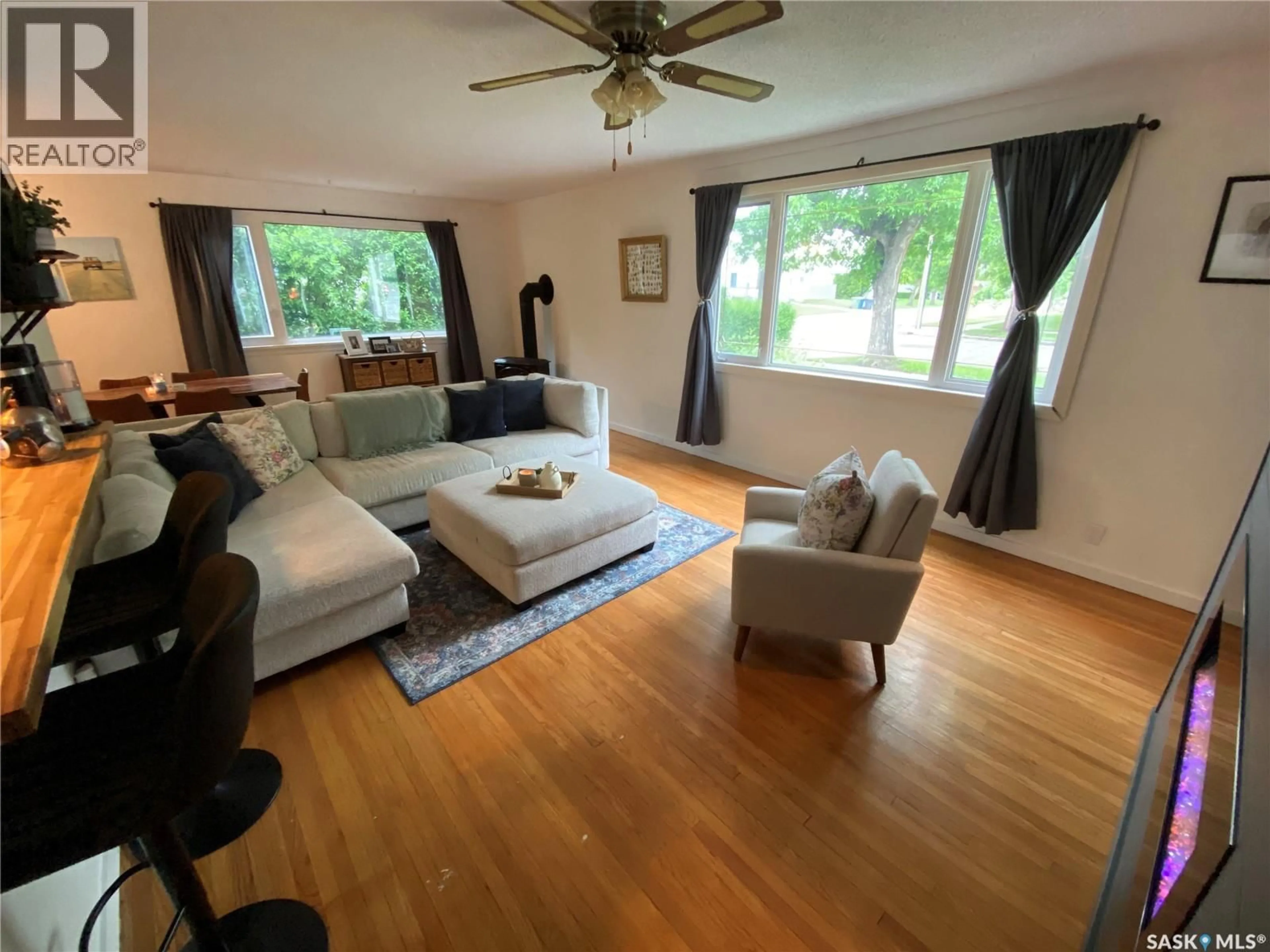 Living room with furniture, wood/laminate floor for 91 HAULTAIN AVENUE, Yorkton Saskatchewan S3N1X6