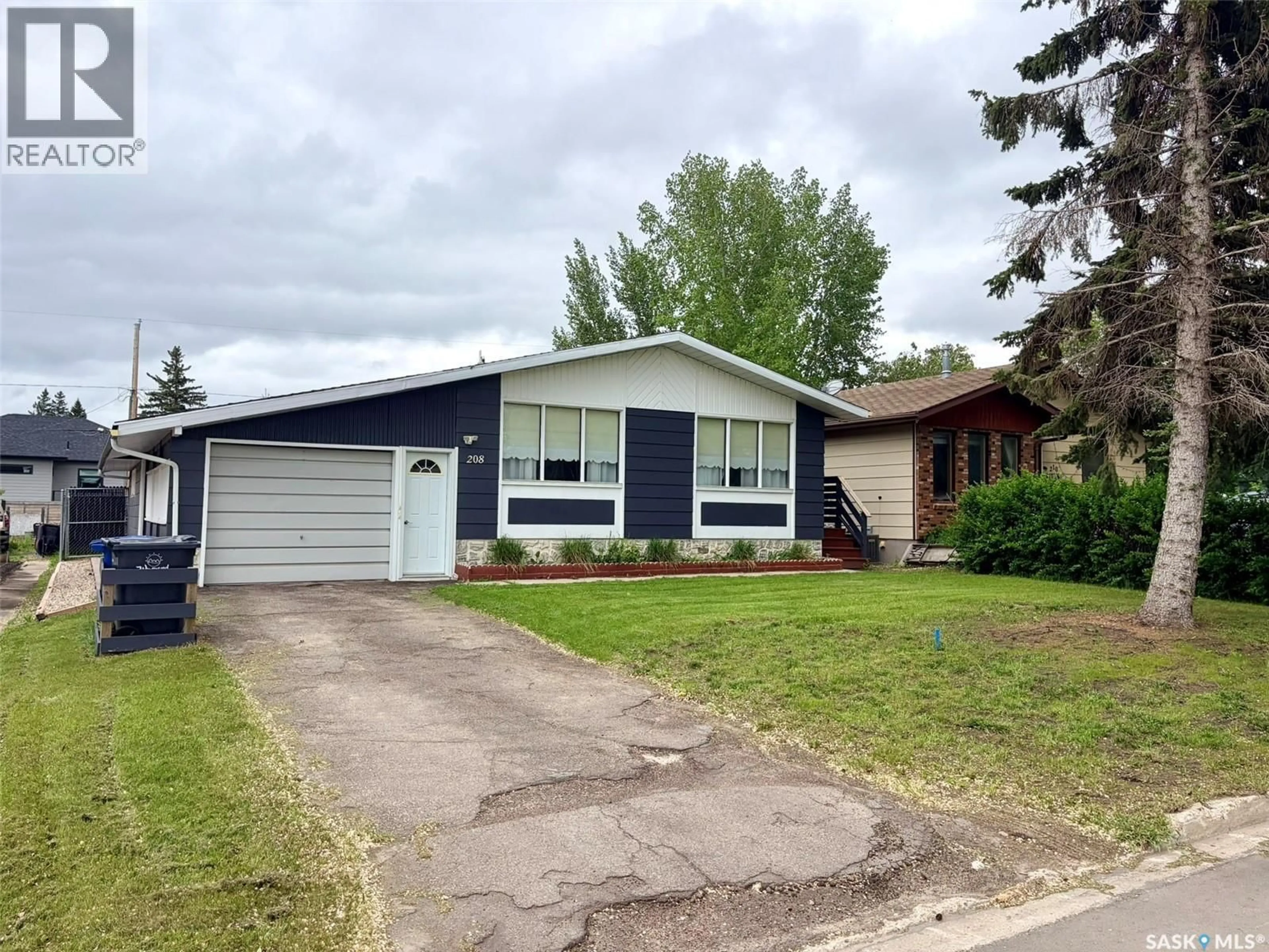 Home with vinyl exterior material, street for E - 208 7TH STREET, Wynyard Saskatchewan S0A4T0
