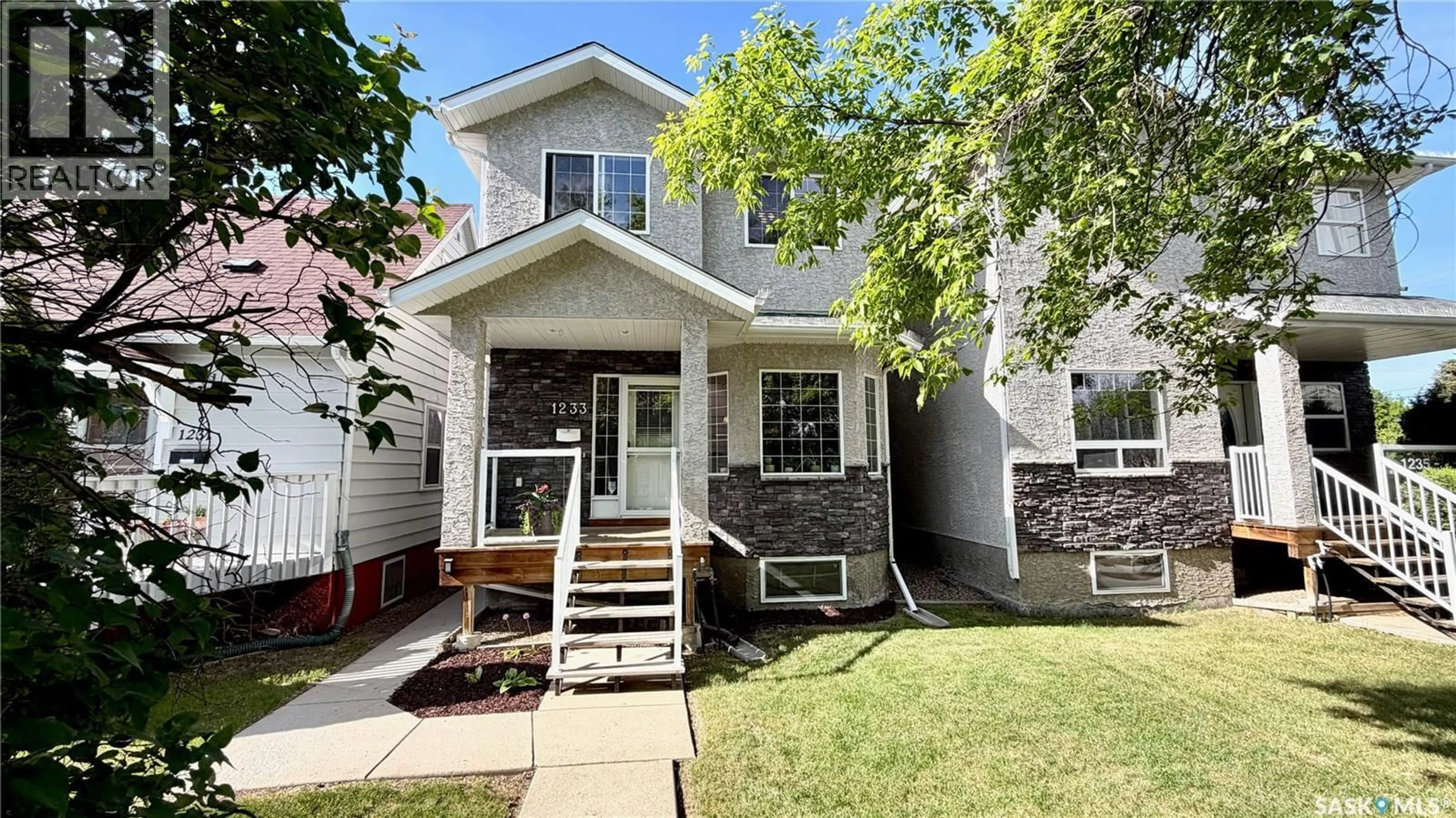 Home with vinyl exterior material, street for 1233 13TH STREET, Saskatoon Saskatchewan S7H0C3
