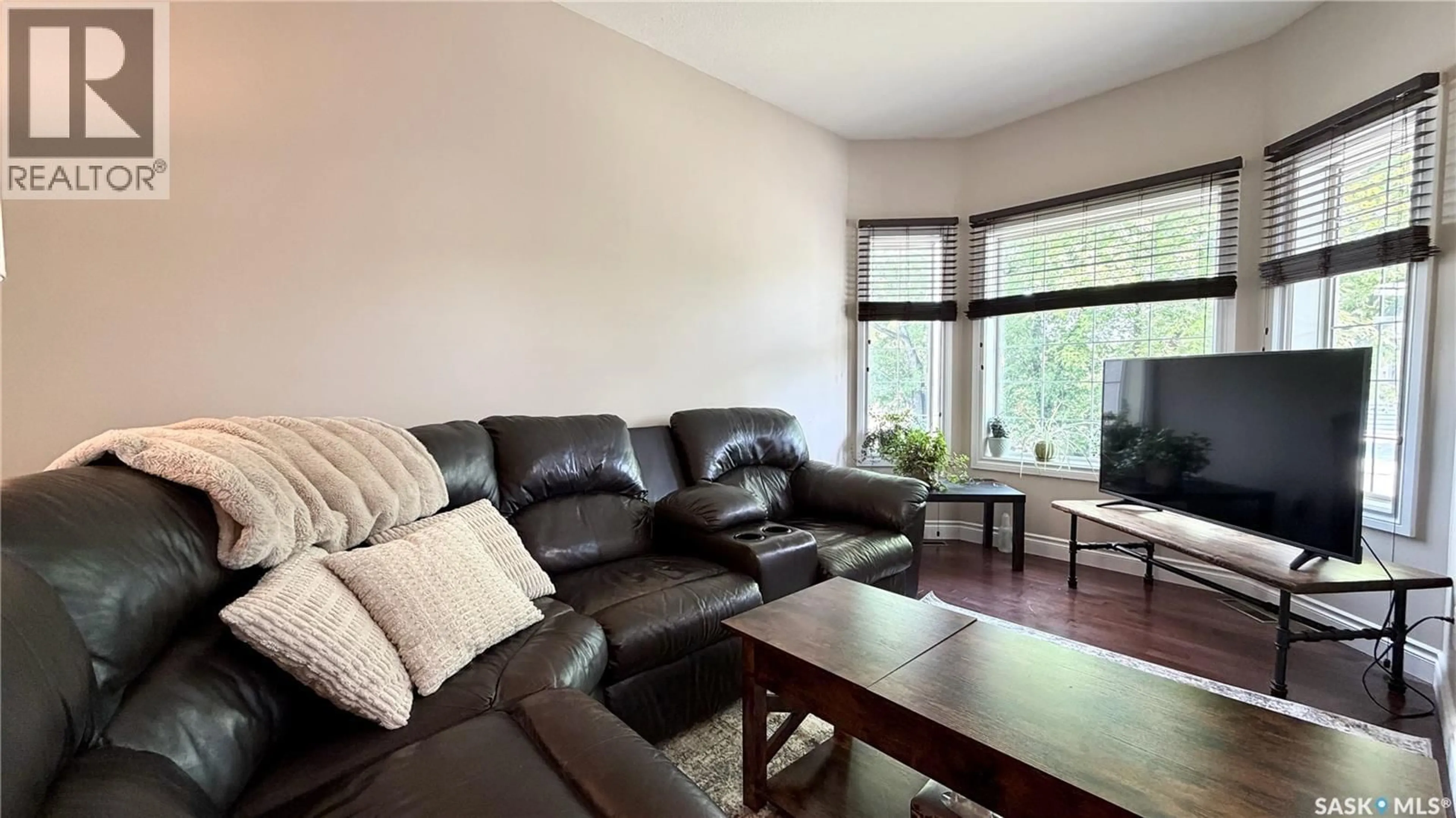 Living room with furniture, wood/laminate floor for 1233 13TH STREET, Saskatoon Saskatchewan S7H0C3