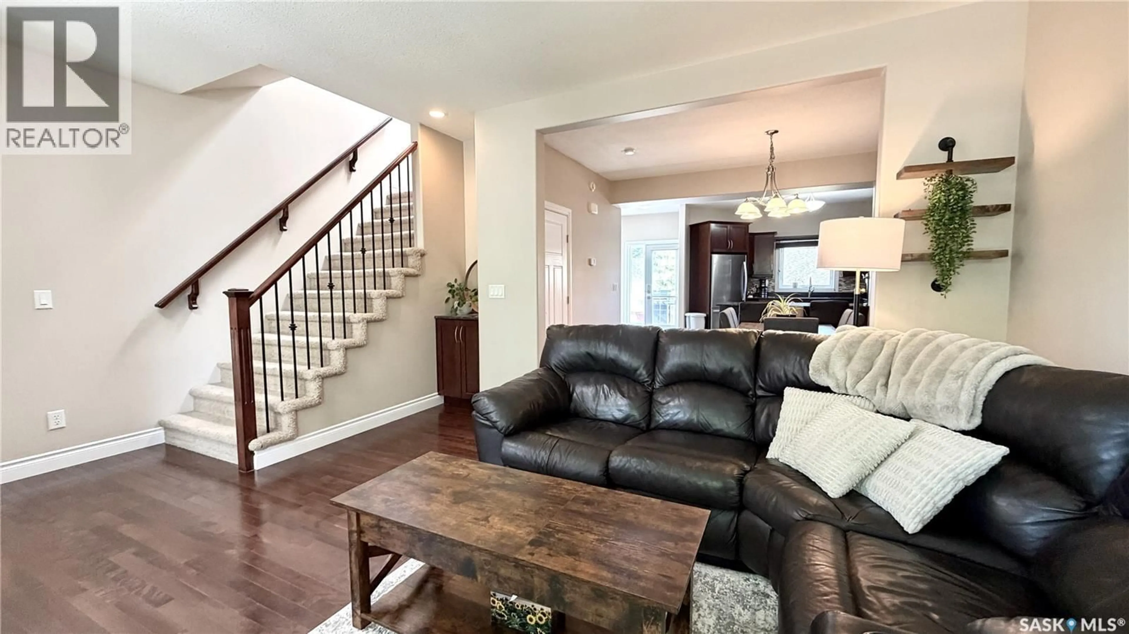 Living room with furniture, wood/laminate floor for 1233 13TH STREET, Saskatoon Saskatchewan S7H0C3