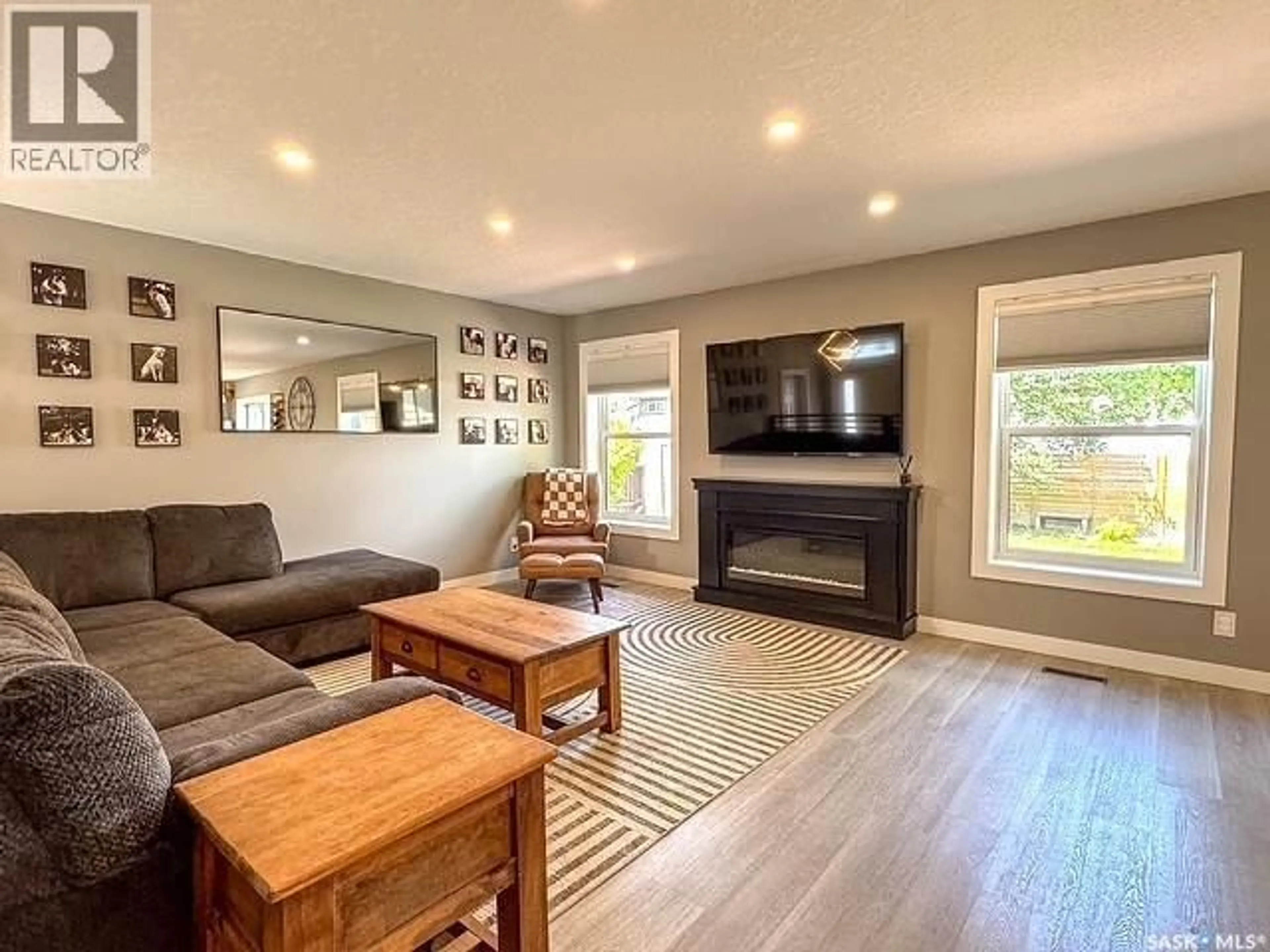 Living room with furniture, wood/laminate floor for 482 RUSSELL CRESCENT, Swift Current Saskatchewan S9H4S7