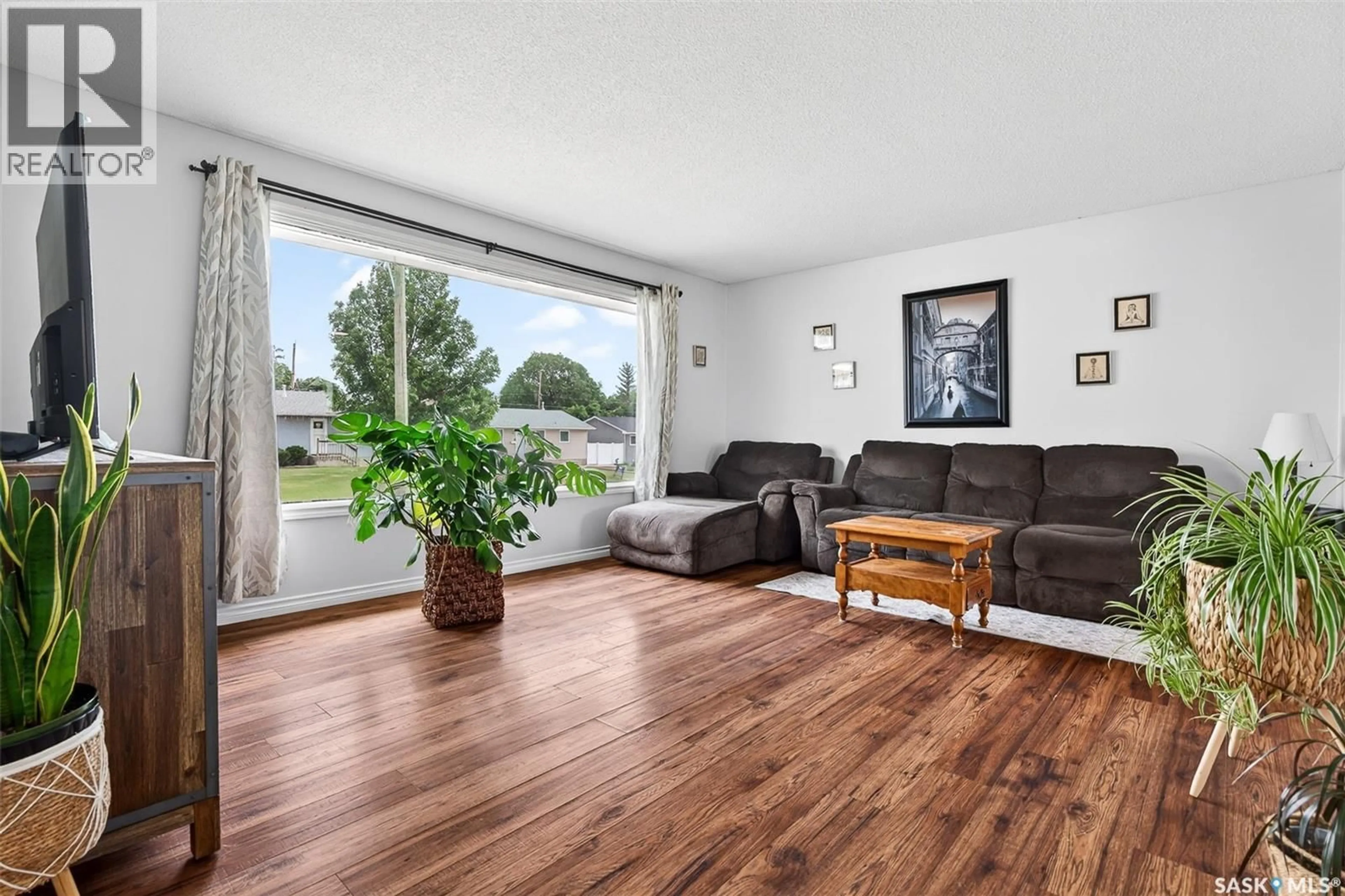Living room with furniture, wood/laminate floor for 1319 STADACONA STREET, Moose Jaw Saskatchewan S6H6M9