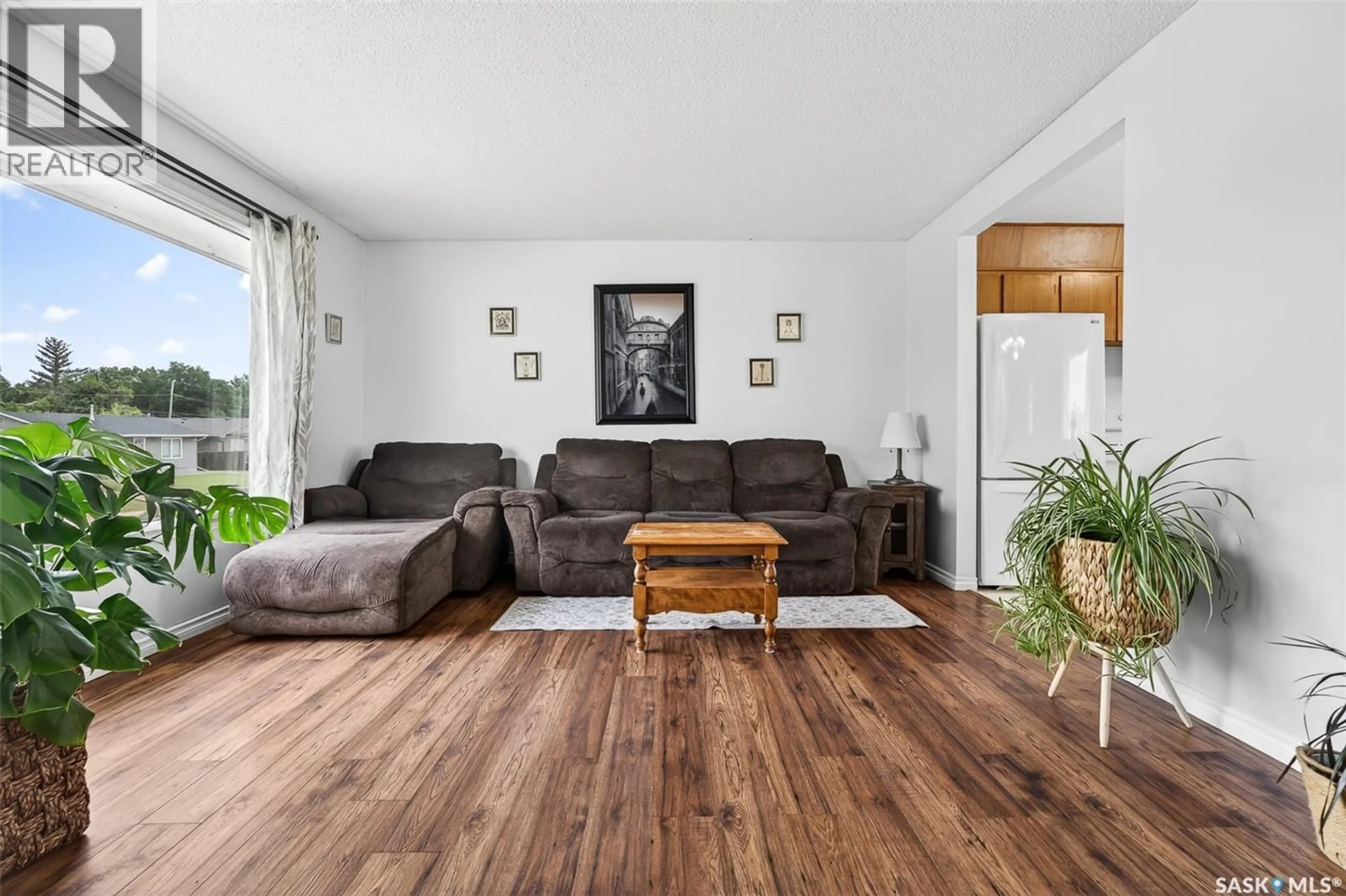 Living room with furniture, wood/laminate floor for 1319 STADACONA STREET, Moose Jaw Saskatchewan S6H6M9