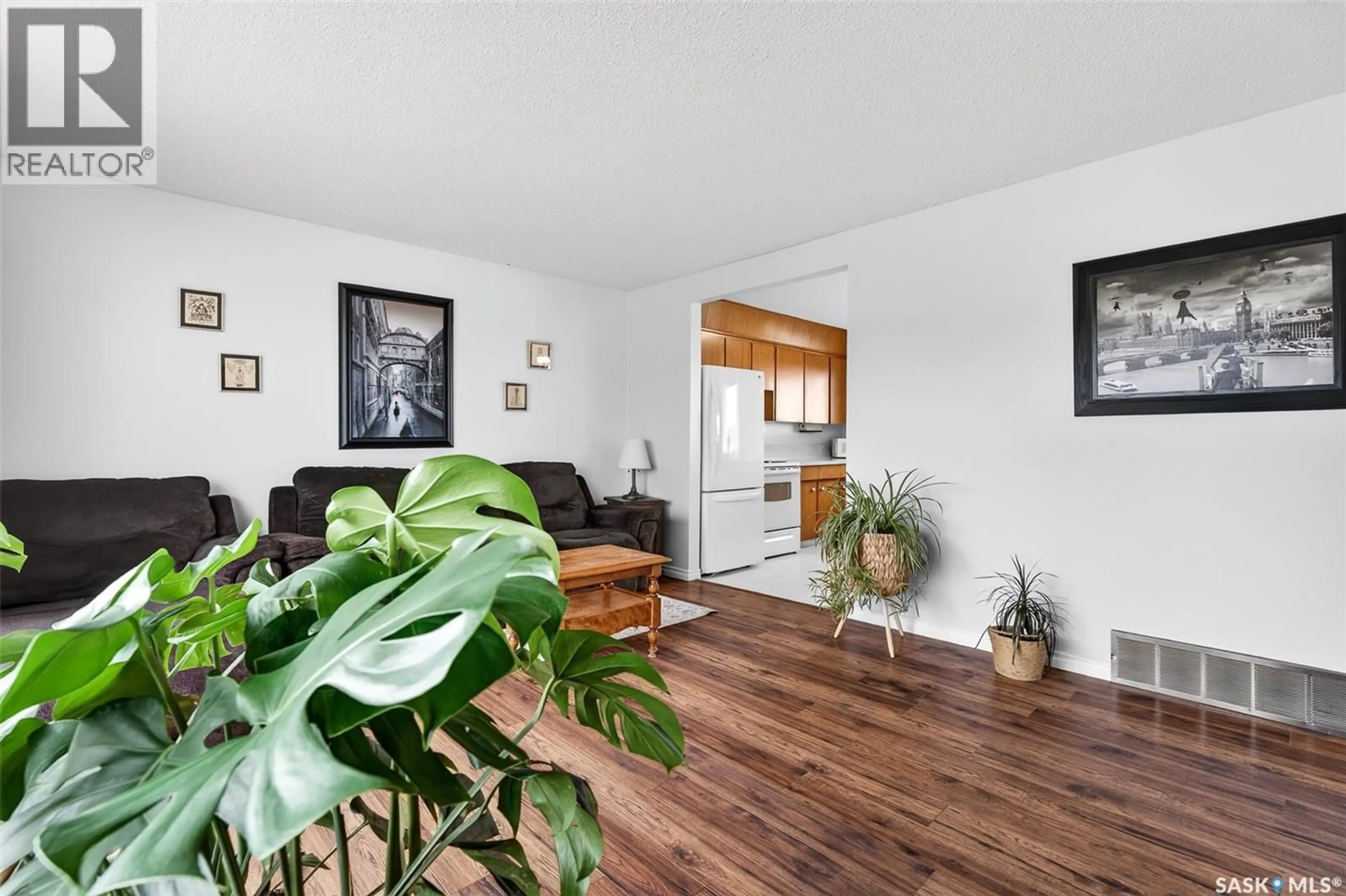 Living room with furniture, wood/laminate floor for 1319 STADACONA STREET, Moose Jaw Saskatchewan S6H6M9