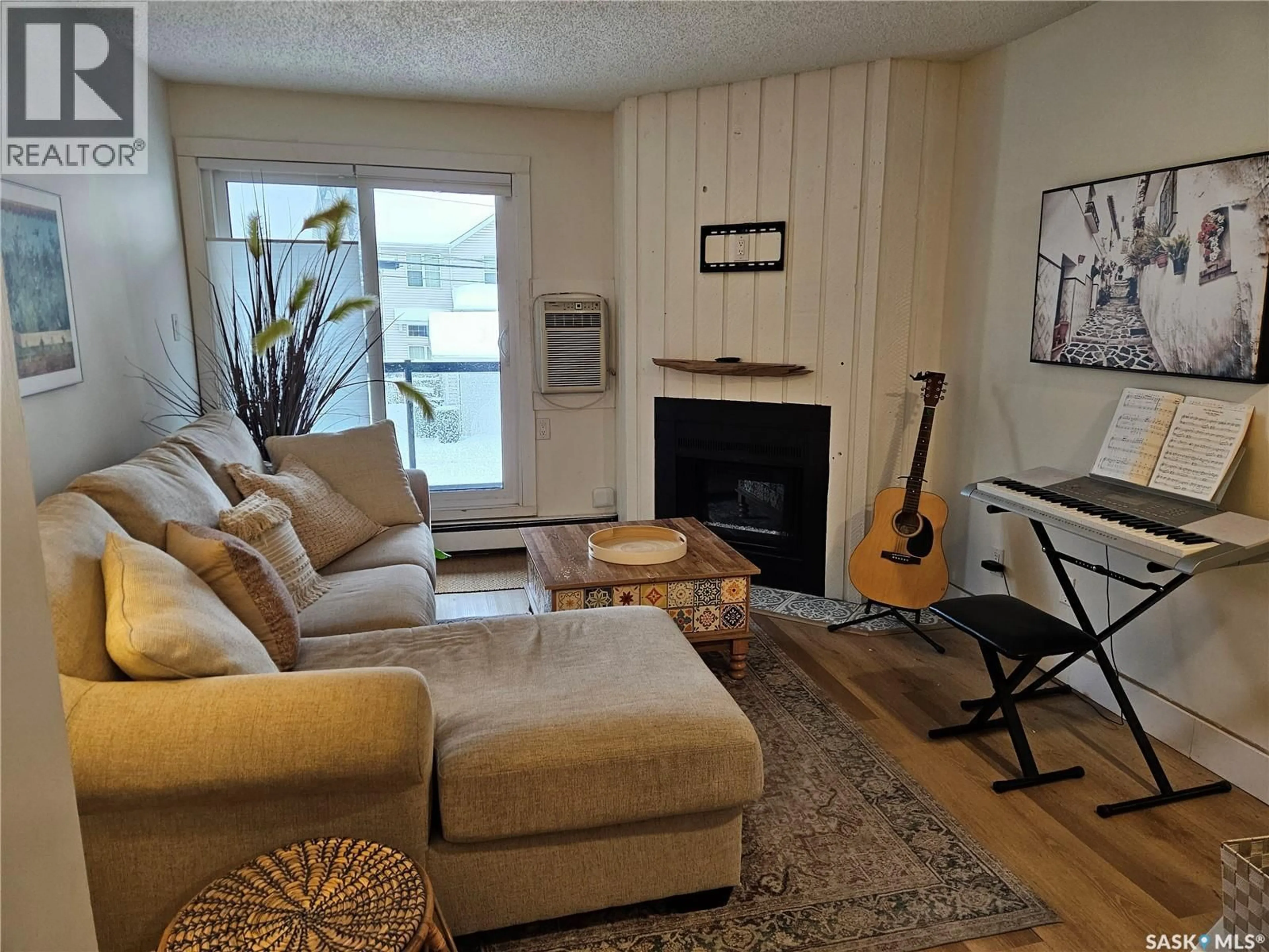Living room with furniture, wood/laminate floor for 207 - 512 4TH AVENUE, Saskatoon Saskatchewan S7K2M7