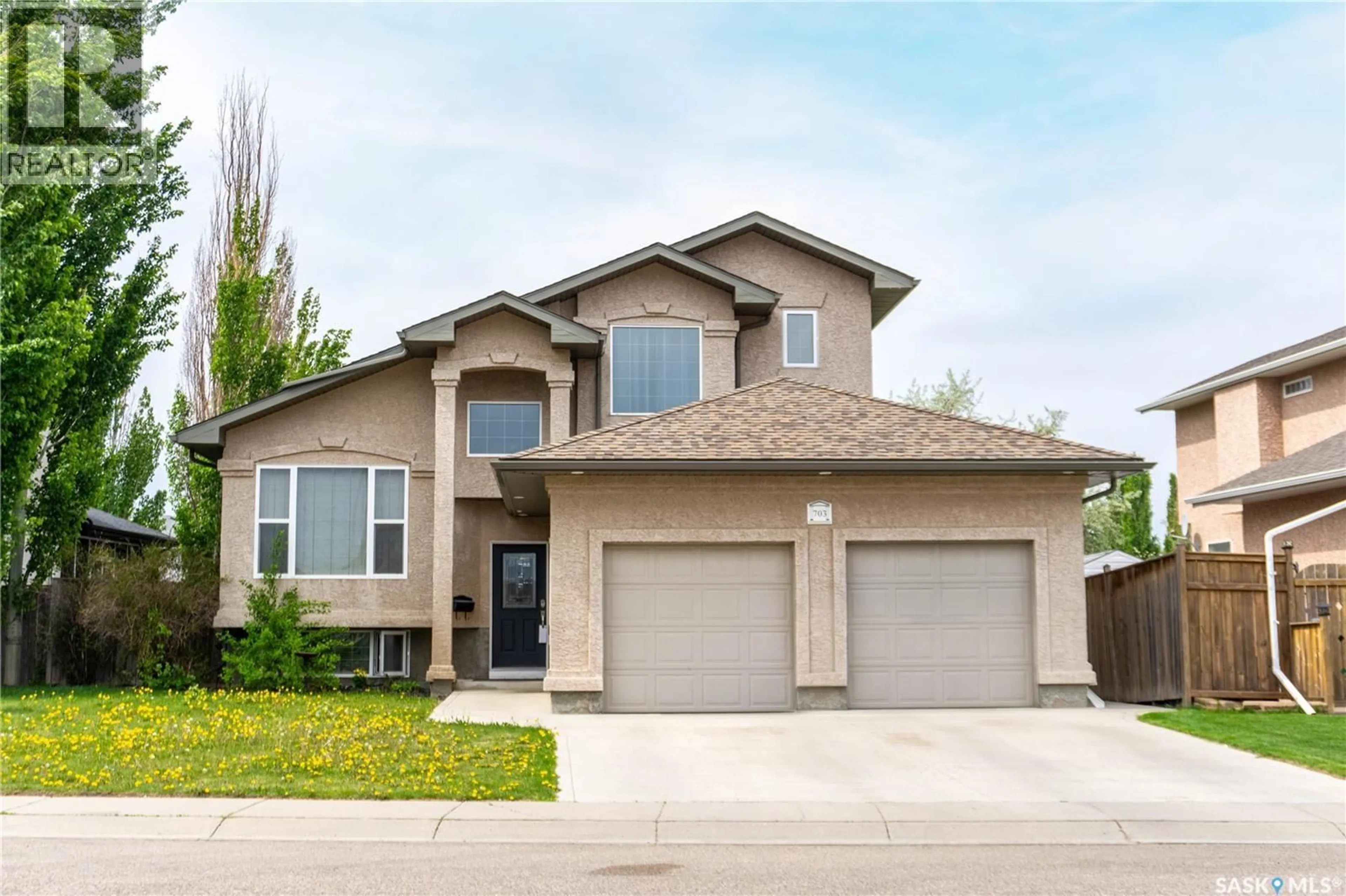 Home with vinyl exterior material, street for 703 BEECHMONT LANE, Saskatoon Saskatchewan S7V1C9