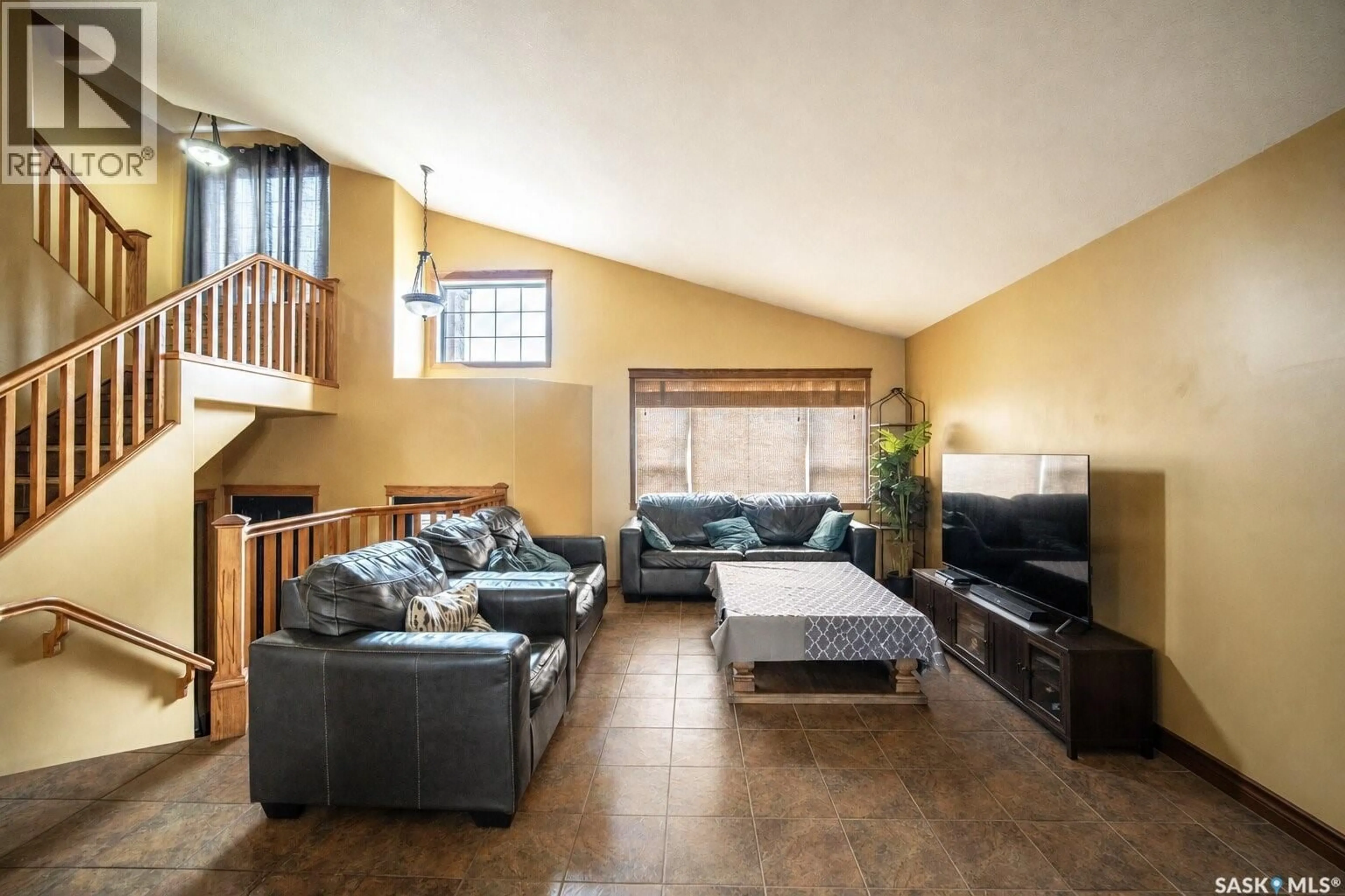 Living room with furniture, ceramic/tile floor for 703 BEECHMONT LANE, Saskatoon Saskatchewan S7V1C9