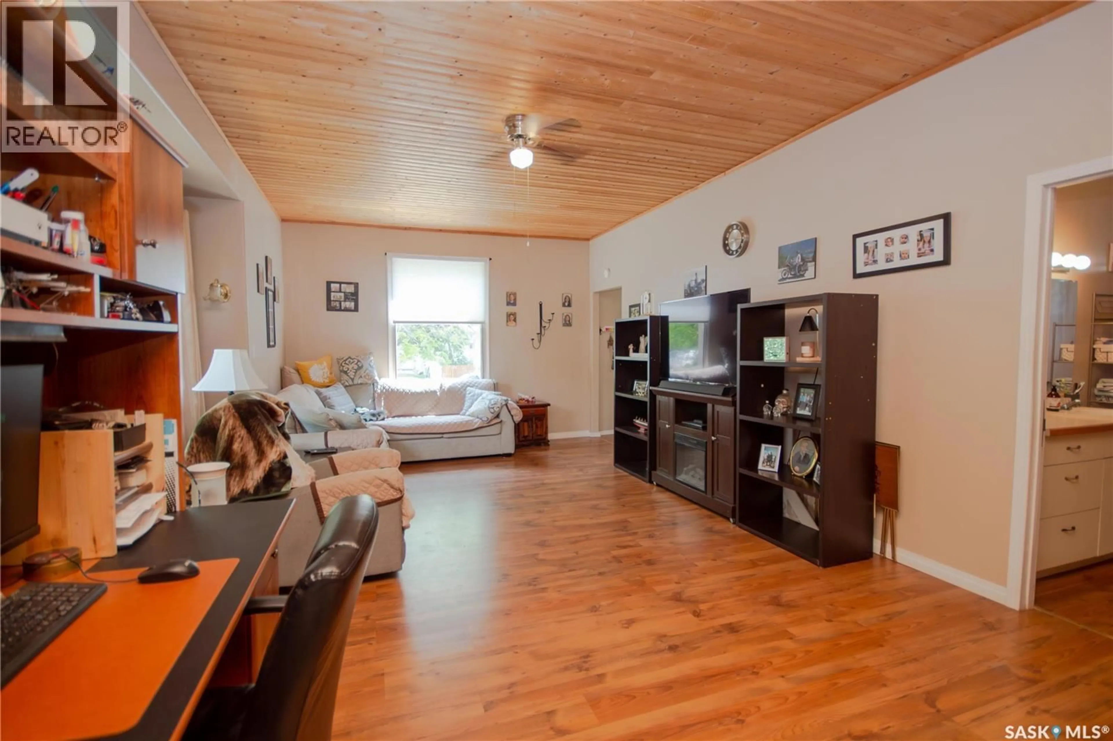 Living room with furniture, wood/laminate floor for 407 2ND STREET, Wilkie Saskatchewan S0K4W0