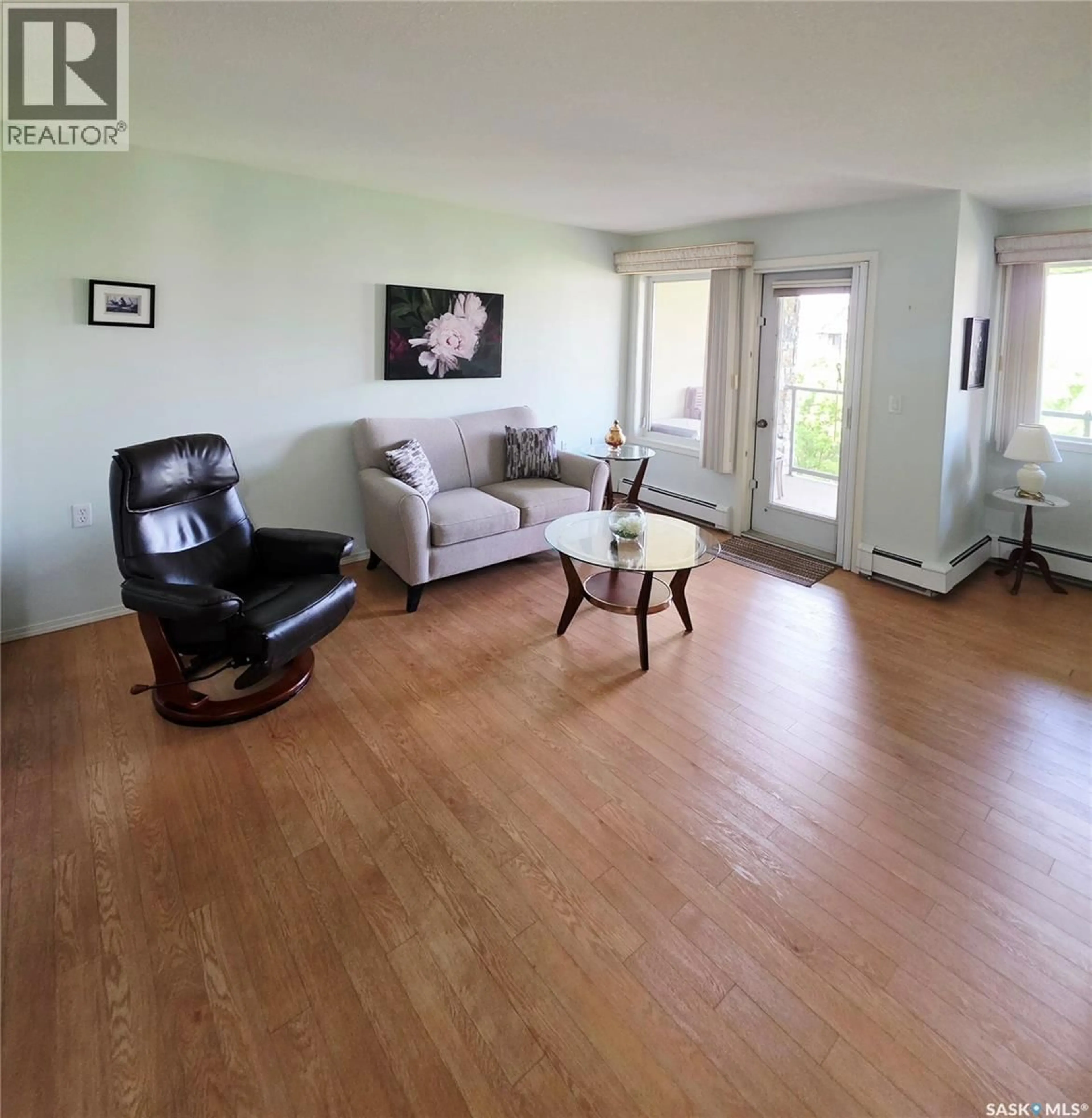 Living room with furniture, wood/laminate floor for 408 1622 ACADIA DRIVE, Saskatoon Saskatchewan S7H5H7