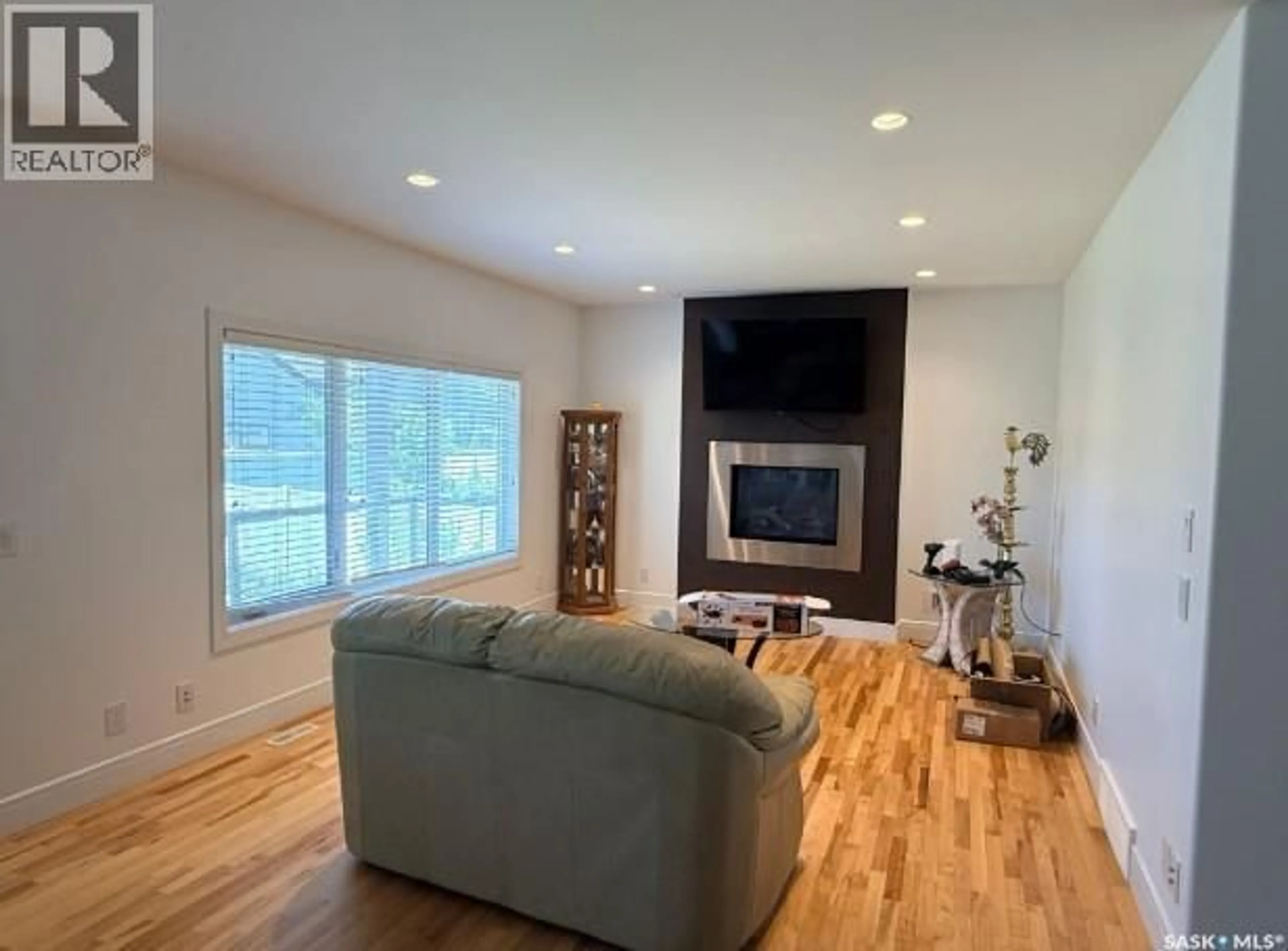 Living room with furniture, wood/laminate floor for 242 POHORECKY STREET, Saskatoon Saskatchewan S7W0J3