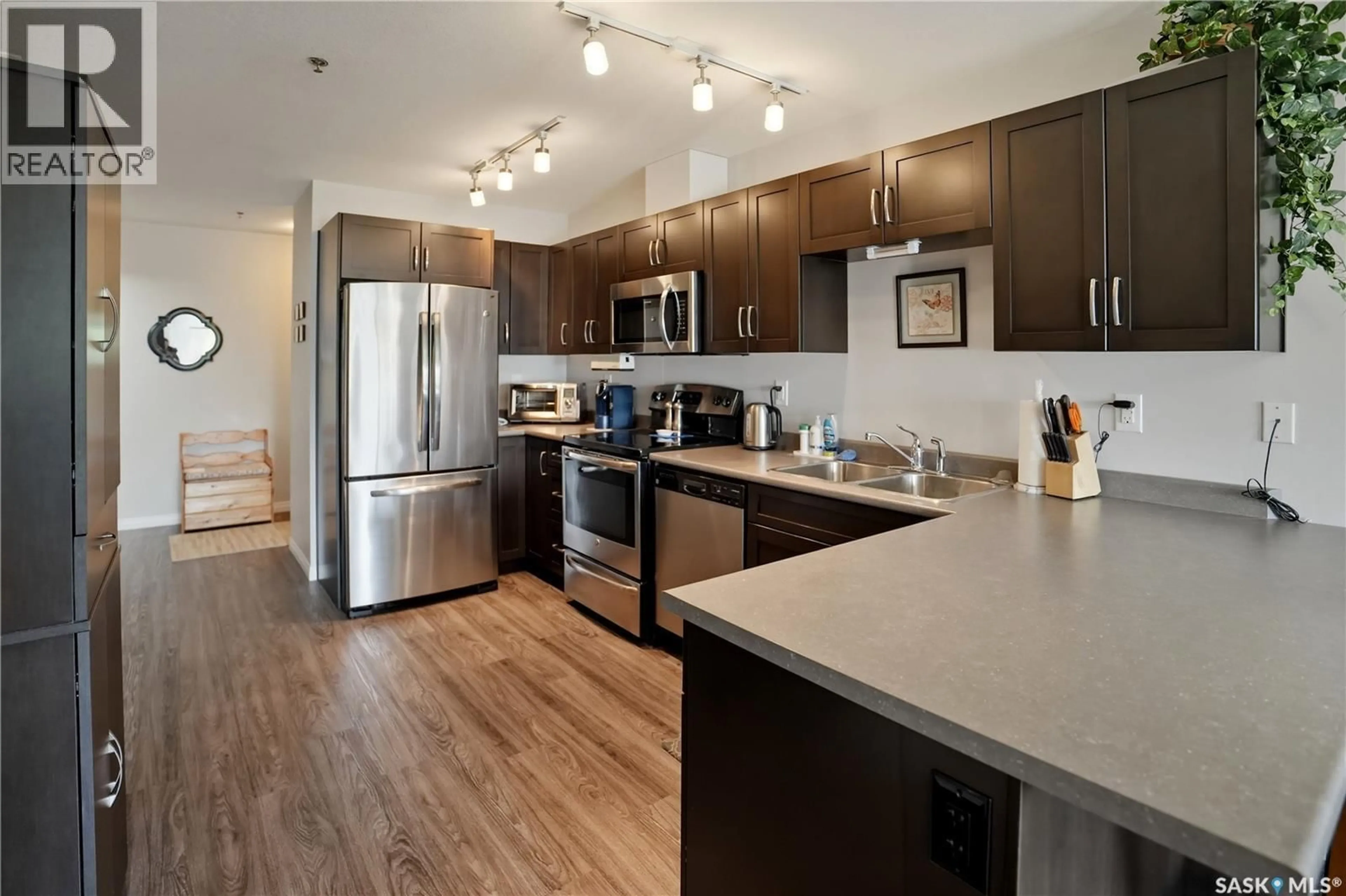 Open concept kitchen, wood/laminate floor for 308 - 2452 KILLDEER DRIVE, North Battleford Saskatchewan S9A3T5