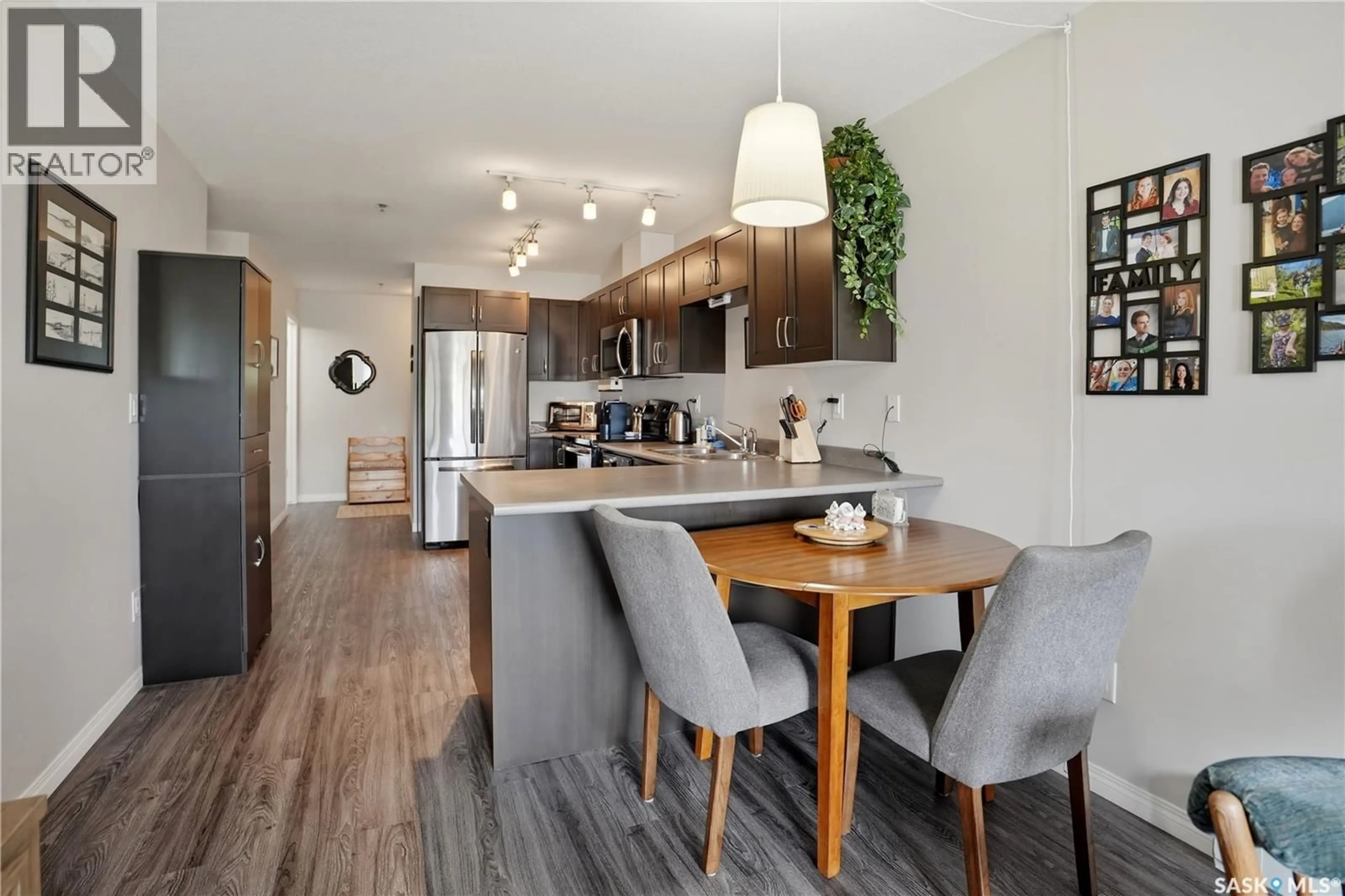 Open concept kitchen, wood/laminate floor for 308 - 2452 KILLDEER DRIVE, North Battleford Saskatchewan S9A3T5