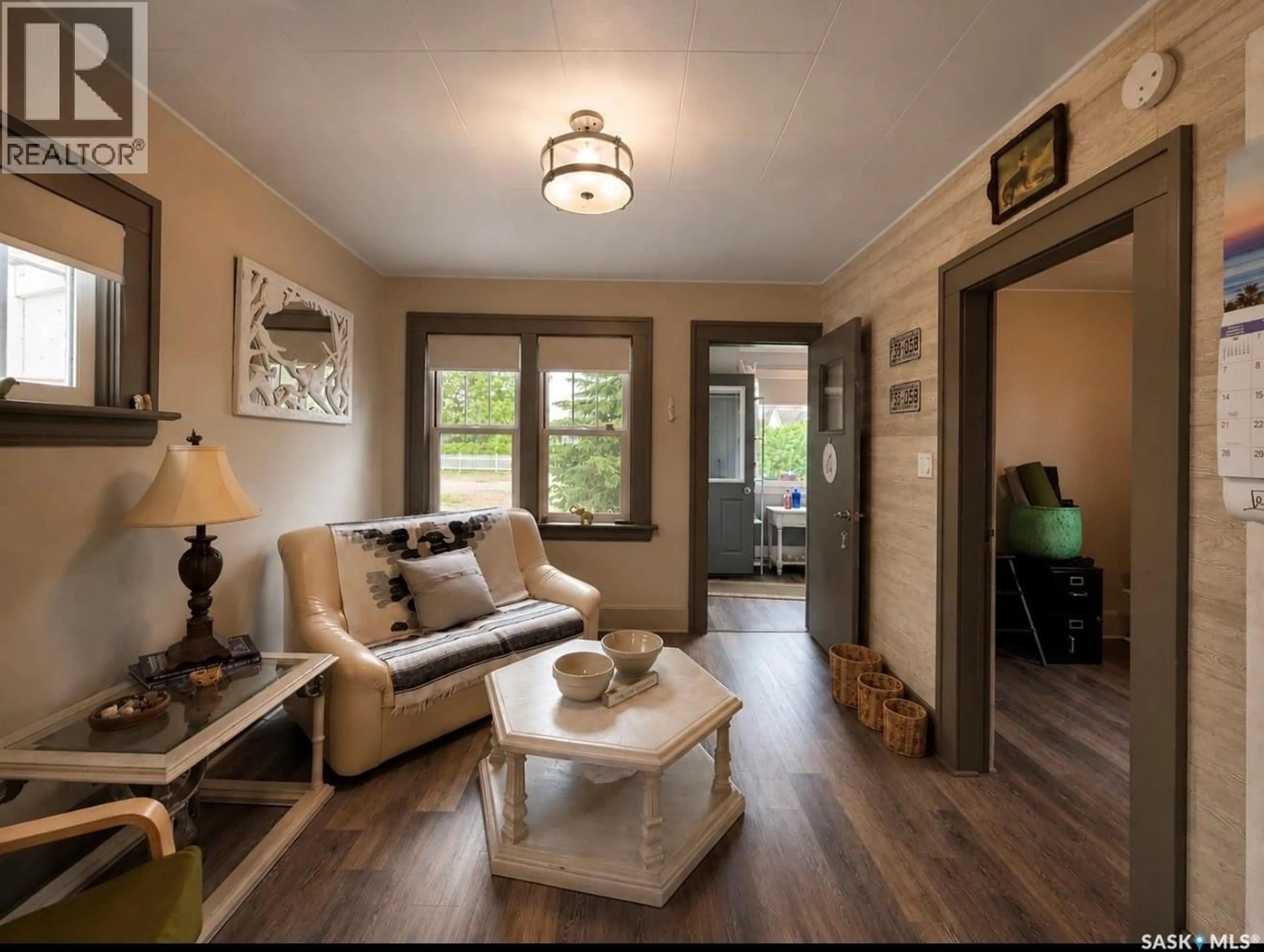 Living room with furniture, wood/laminate floor for 107 4TH AVENUE, Lucky Lake Saskatchewan S0L1Z0