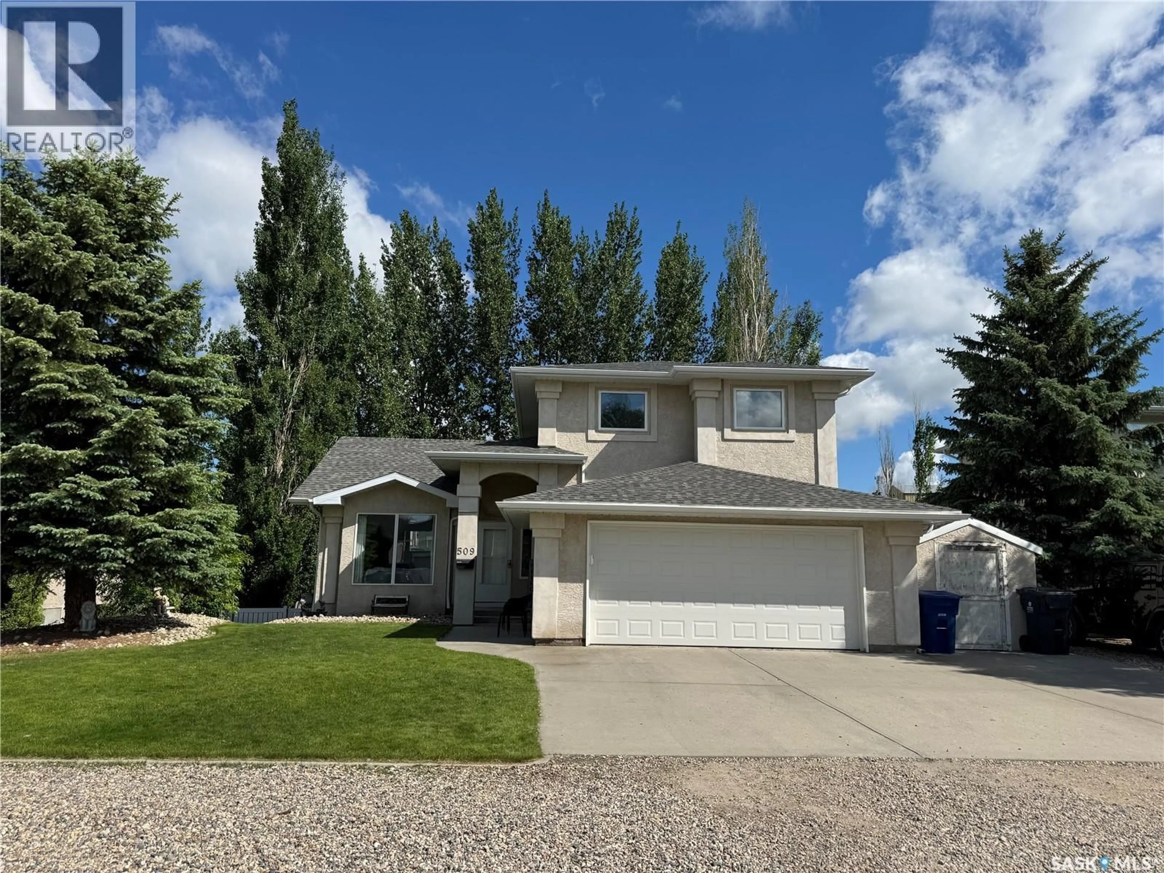 Home with vinyl exterior material, street for 509 MEADOW ROAD, Pilot Butte Saskatchewan S0G3Z0