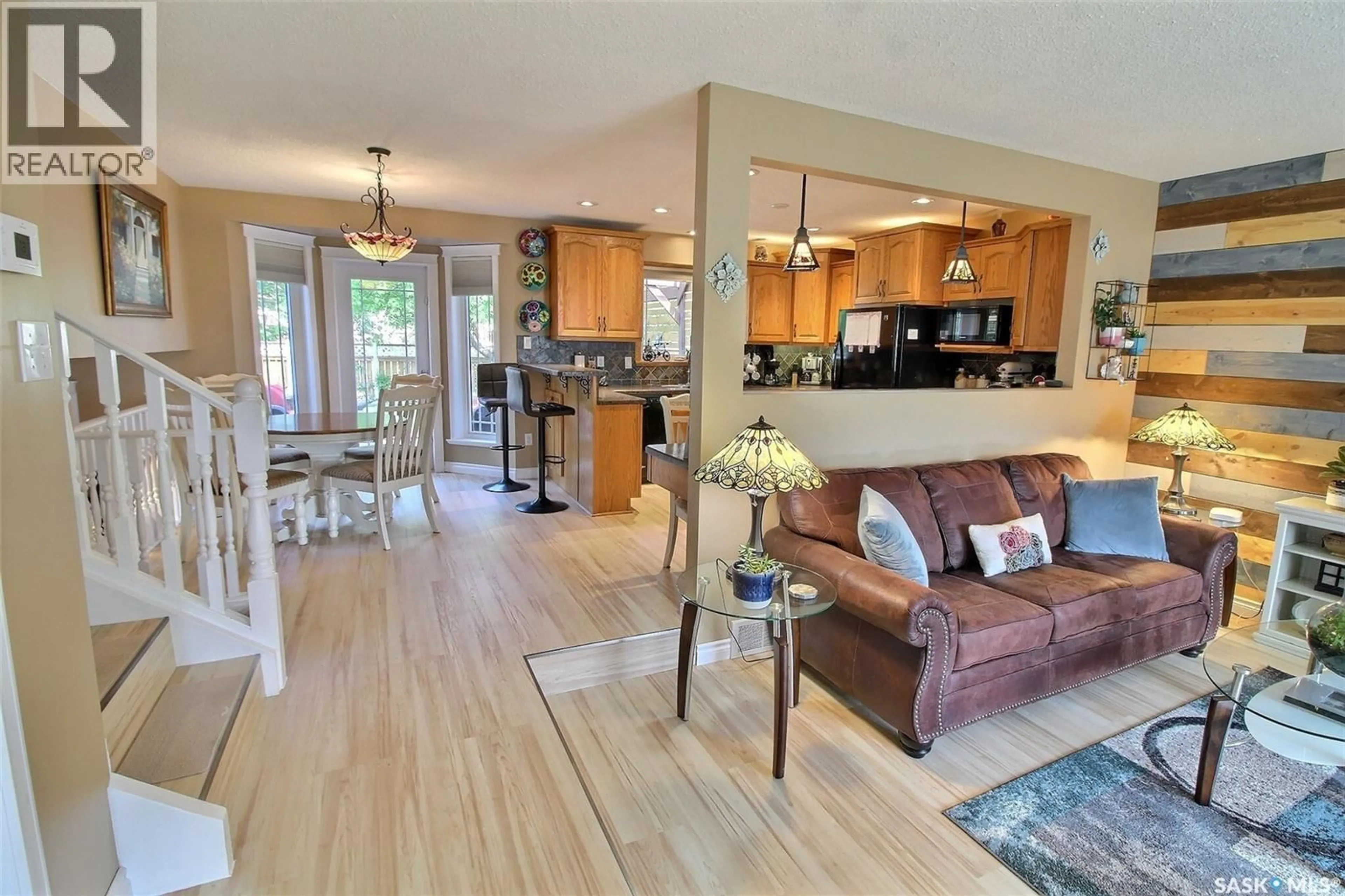 Open concept kitchen, wood/laminate floor for 10 PEREVERZOFF PLACE, Prince Albert Saskatchewan S6X1A5