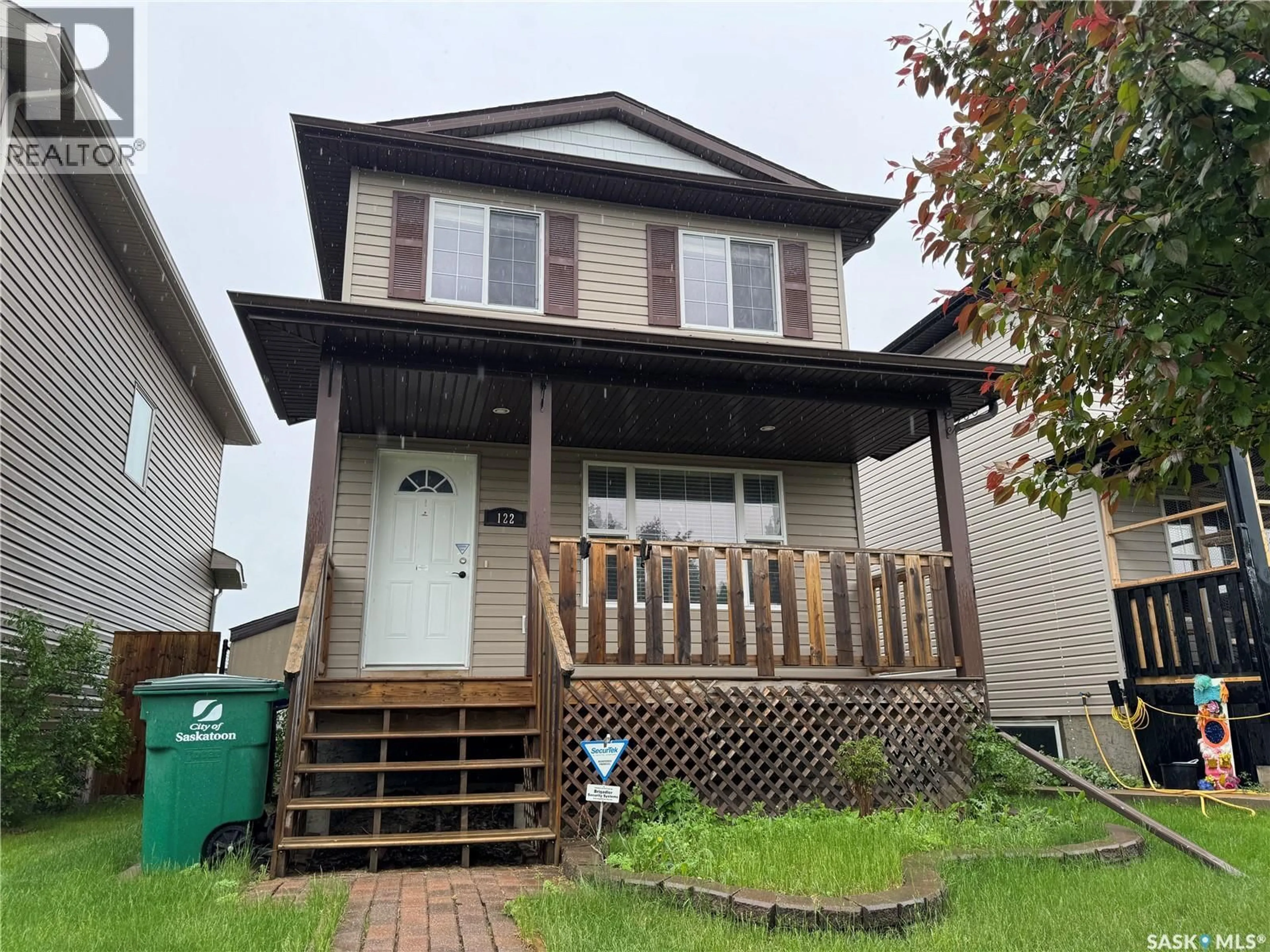 Home with vinyl exterior material, street for 122 KEEDWELL STREET, Saskatoon Saskatchewan S7W1B4