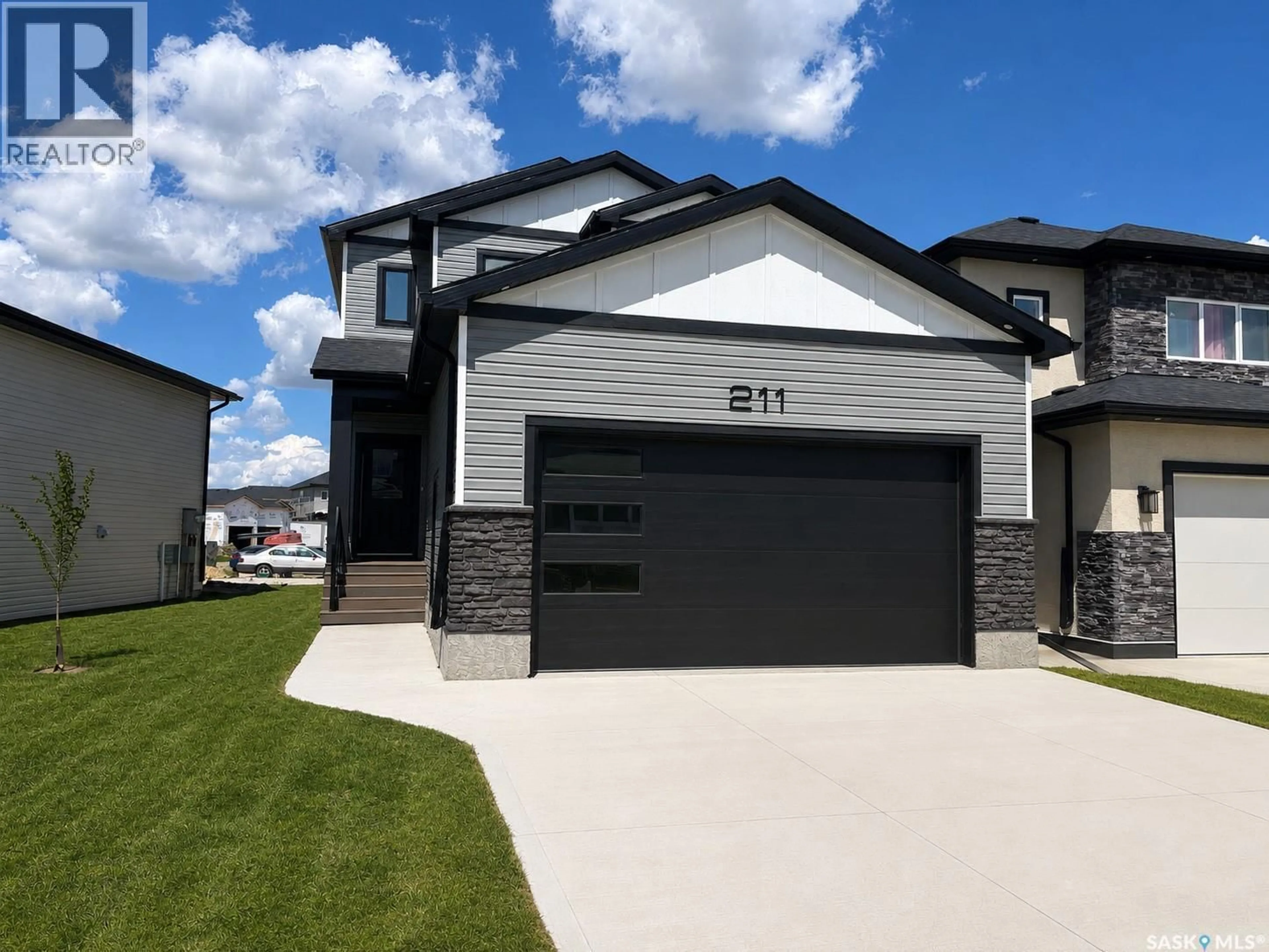 Home with vinyl exterior material, street for 211 SHARMA LANE, Saskatoon Saskatchewan S7W1K7