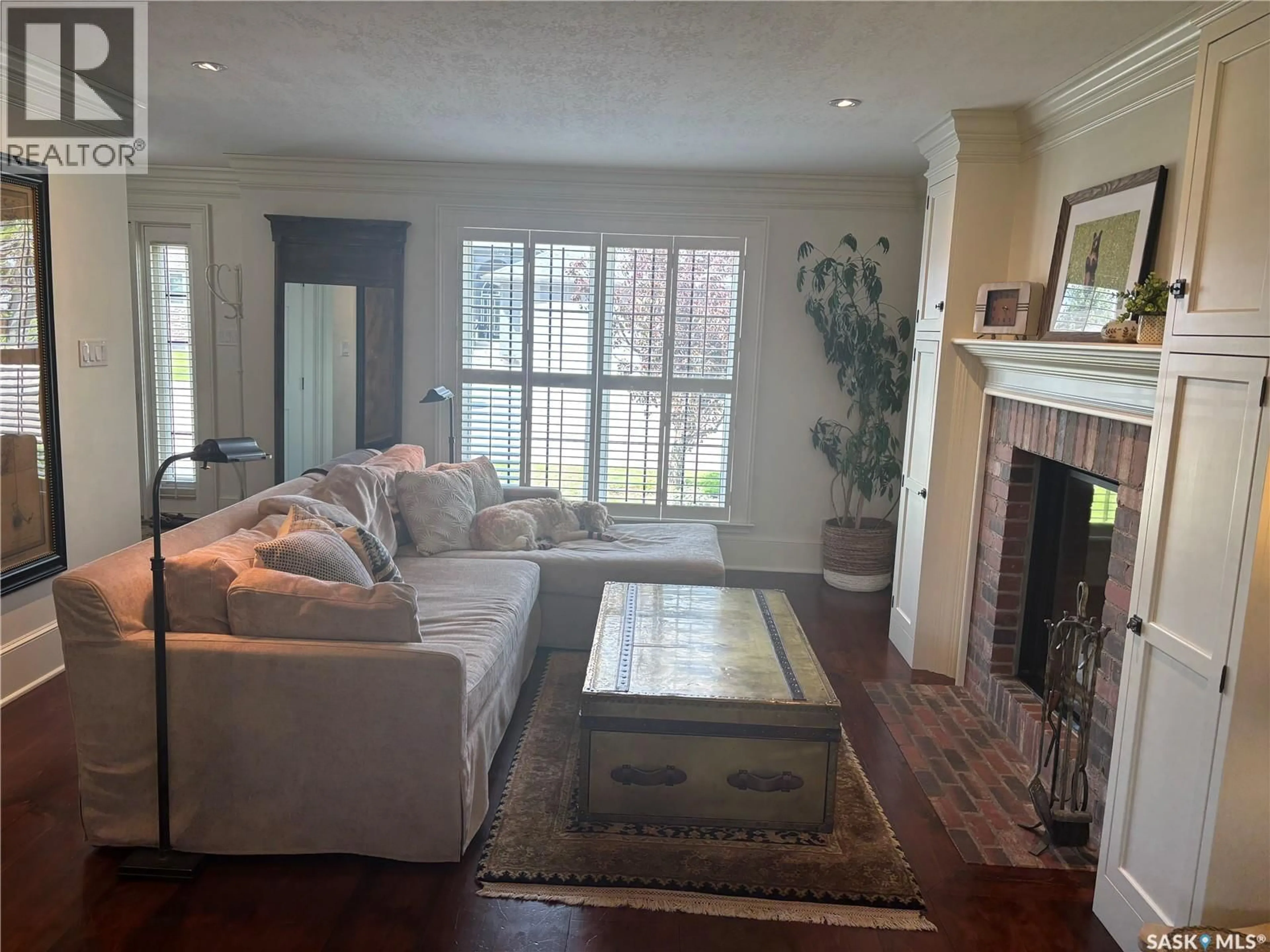 Living room with furniture, wood/laminate floor for 724 ST ANDREWS DRIVE, Swift Current Saskatchewan S9H1L1