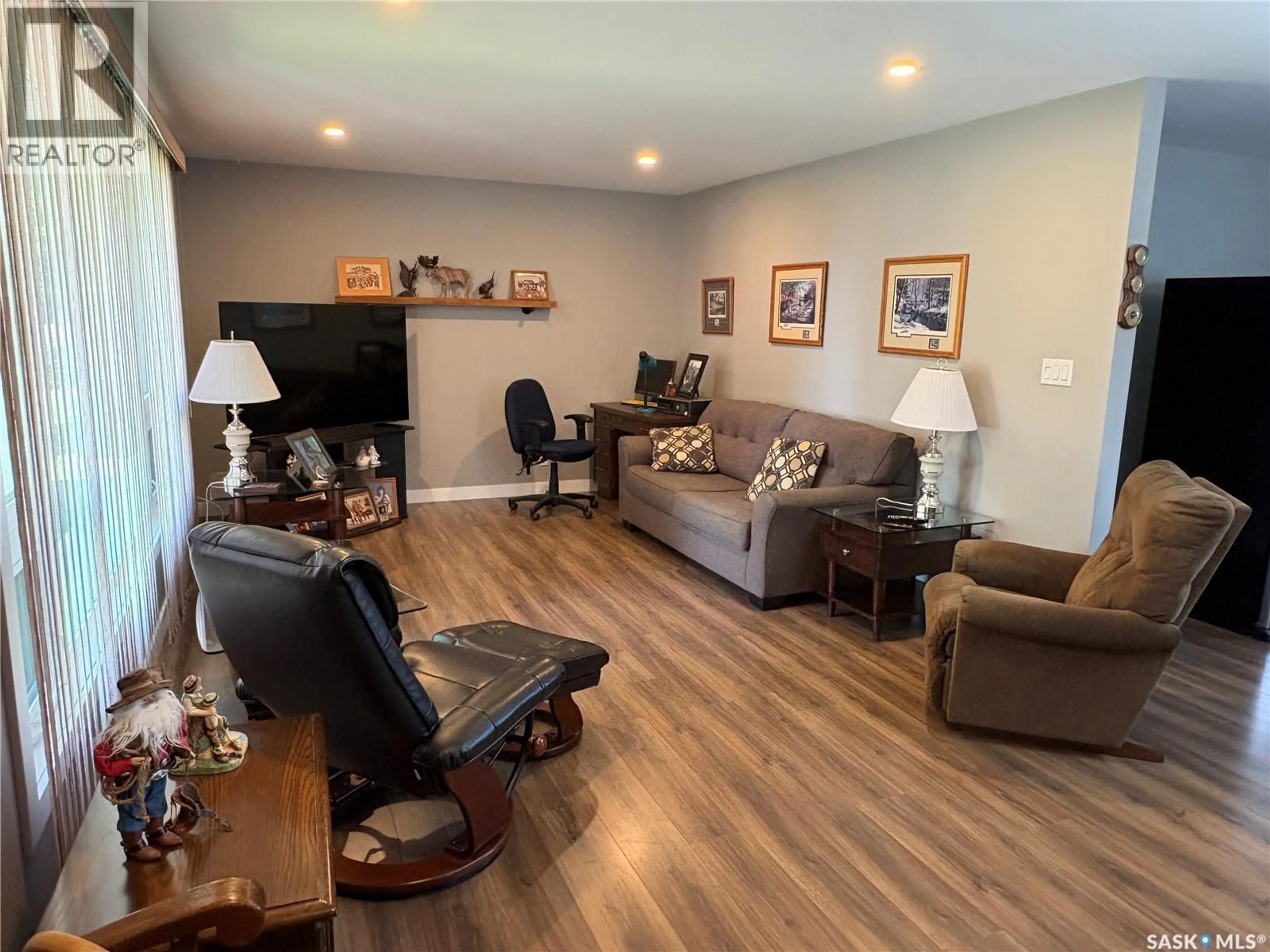 Living room with furniture, wood/laminate floor for 335 CENTRAL AVENUE, Swift Current Saskatchewan S9H3G4